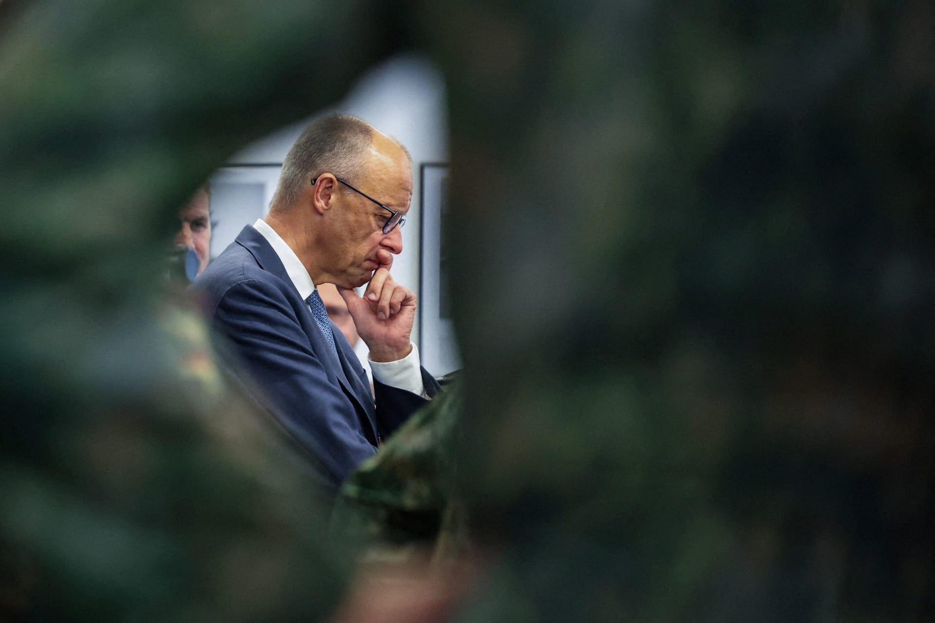 German Chancellor Friedrich Merz listens to the soldiers presenting the drones as Rutte, Merz and Jetten visit the 1 German-Netherlands Corps (1GNC) in Muenster, Germany, October 1, 2026.