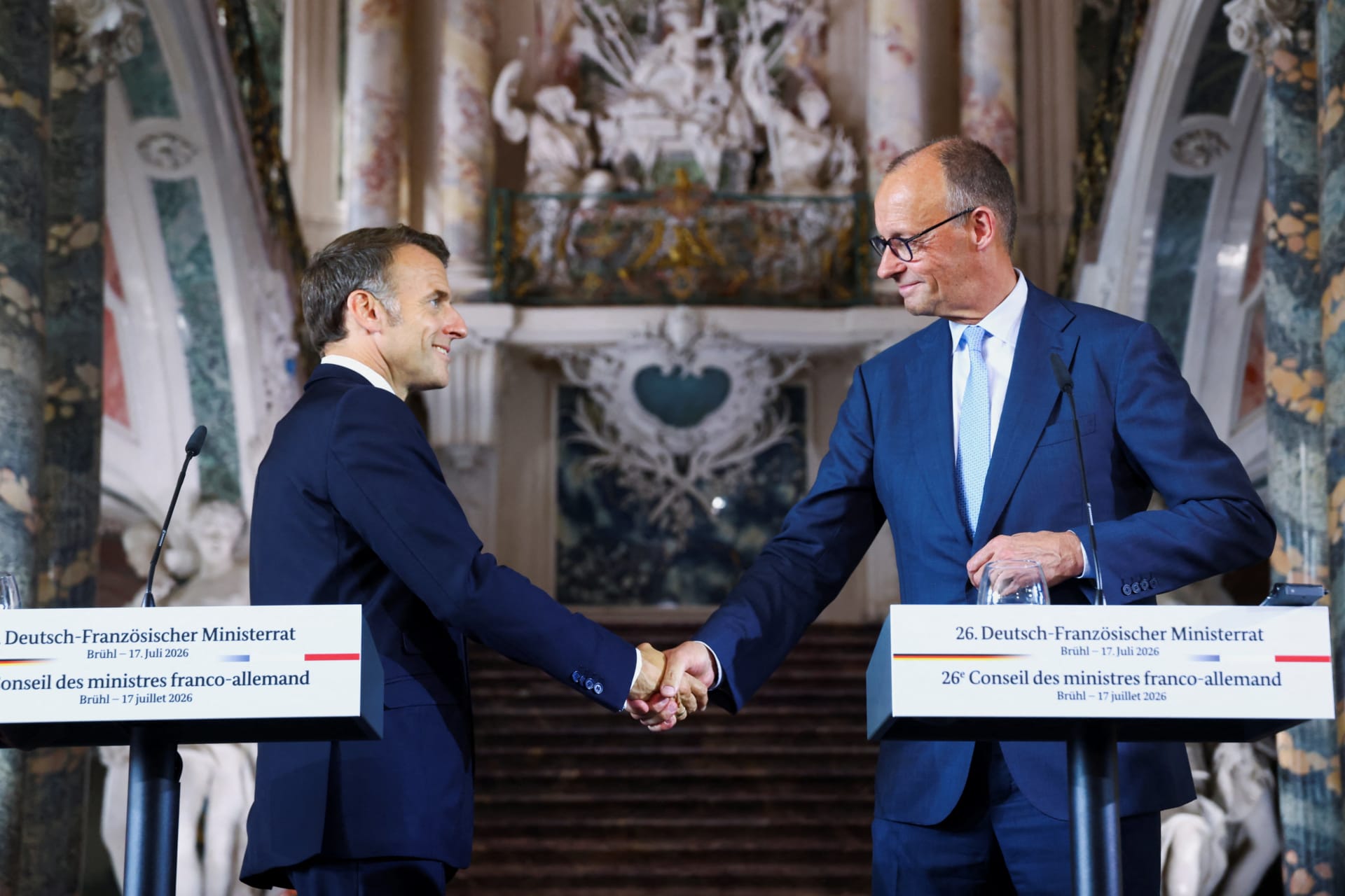 <p>French President Emmanuel Macron and German Chancellor Friedrich Merz shake hands after a press conference at Schloss Augustusburg in Bruehl, Germany, on July 17, 2026.</p>
