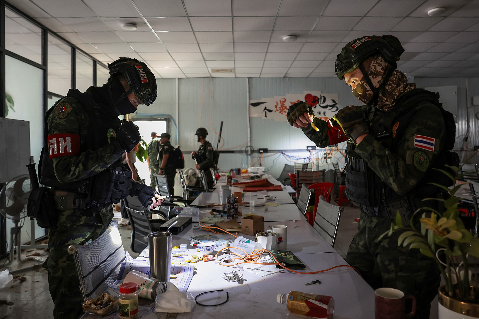 <p>Thai soldiers inspect inside a workstation at a compound that was reportedly used for scam operations, in Samraong, Oddar Meanchey province, Cambodia, on March 6, 2026.</p>
