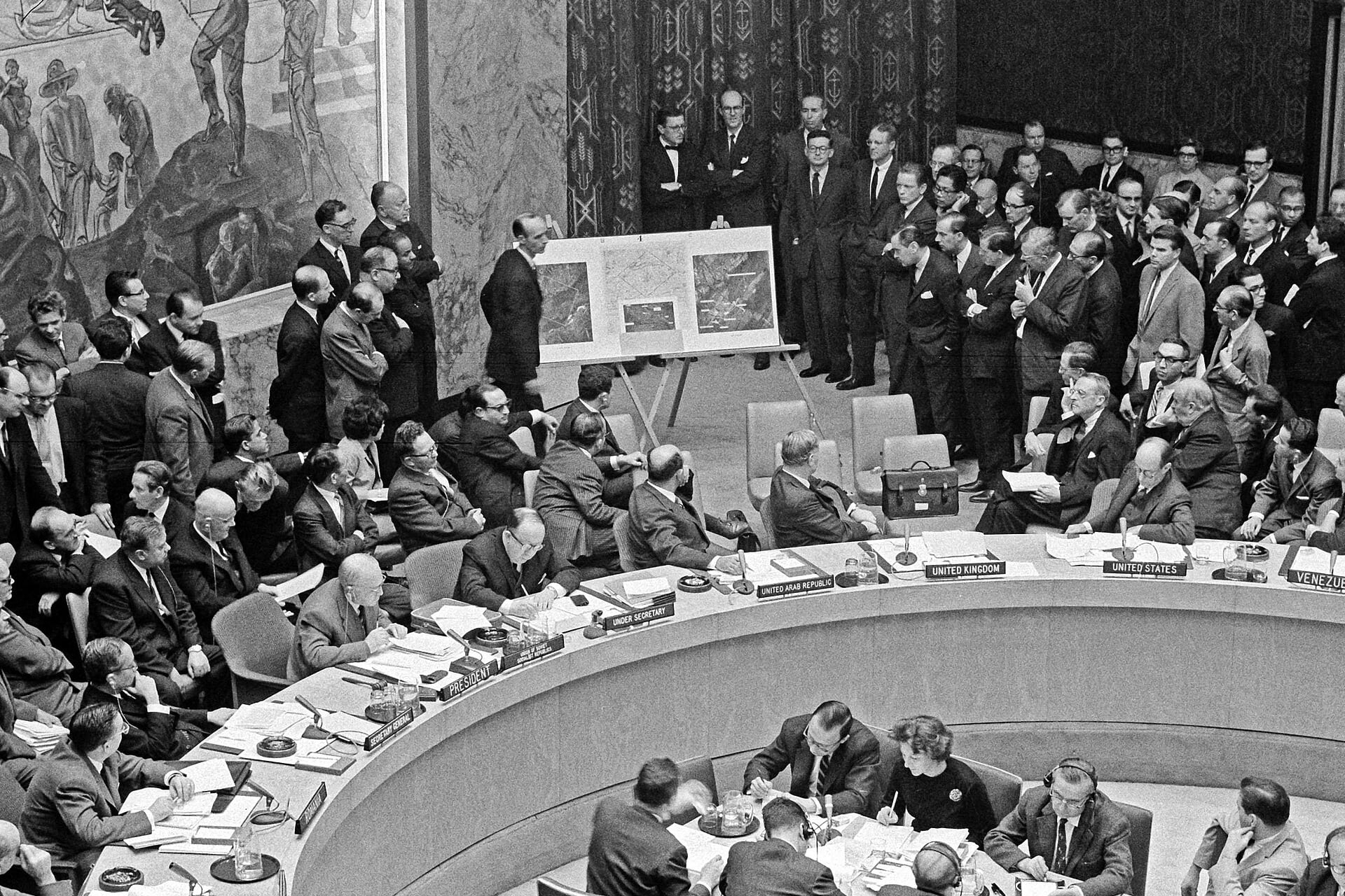 <p>U.S. Ambassador to the United Nations Adlai Stevenson shows aerial photos of Soviet missiles in Cuba to the United Nations Security Council in the presence of Soviet Ambassador Valerian Zorin, October 25, 1962.</p>
