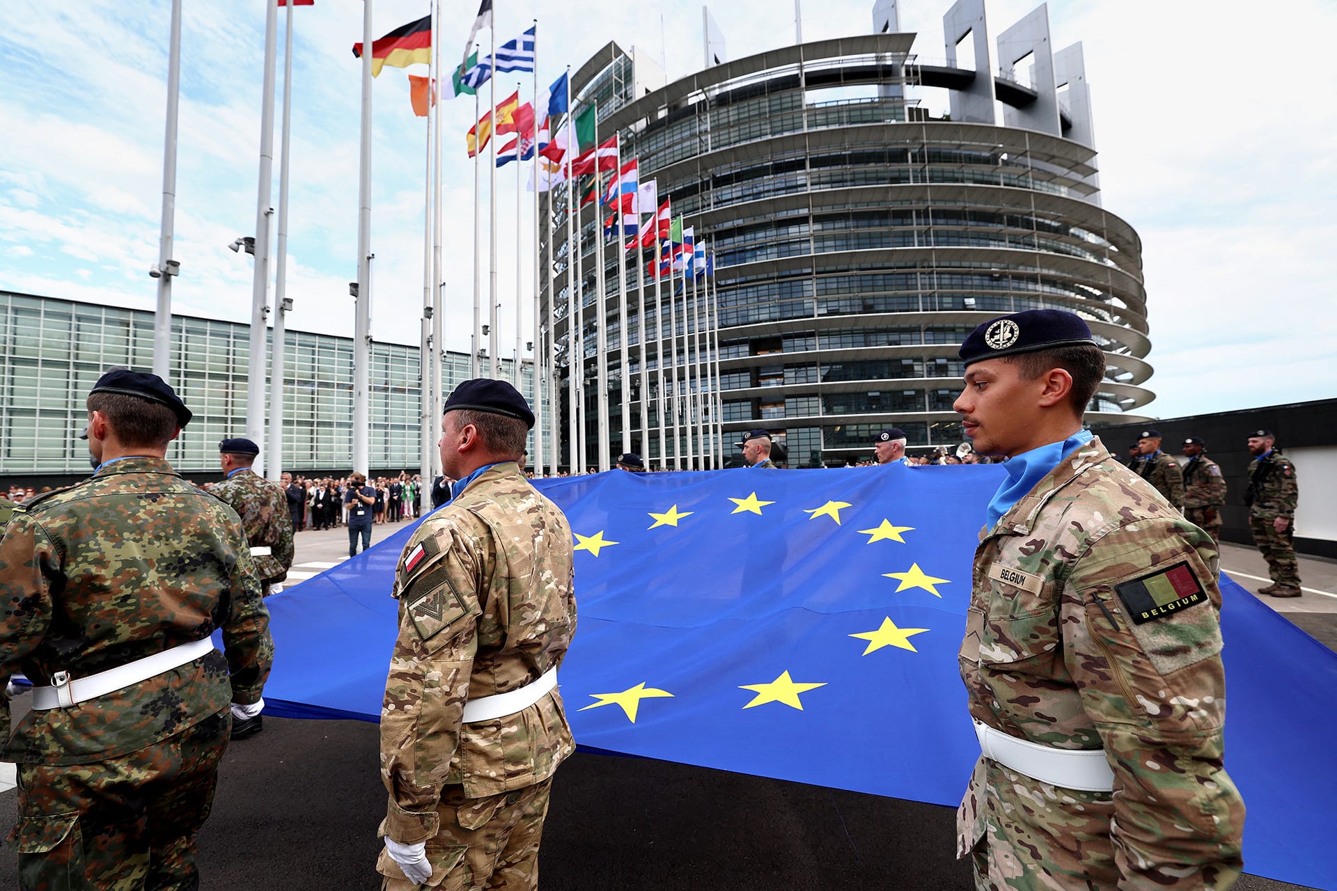 Soldiers standing around an EU flag