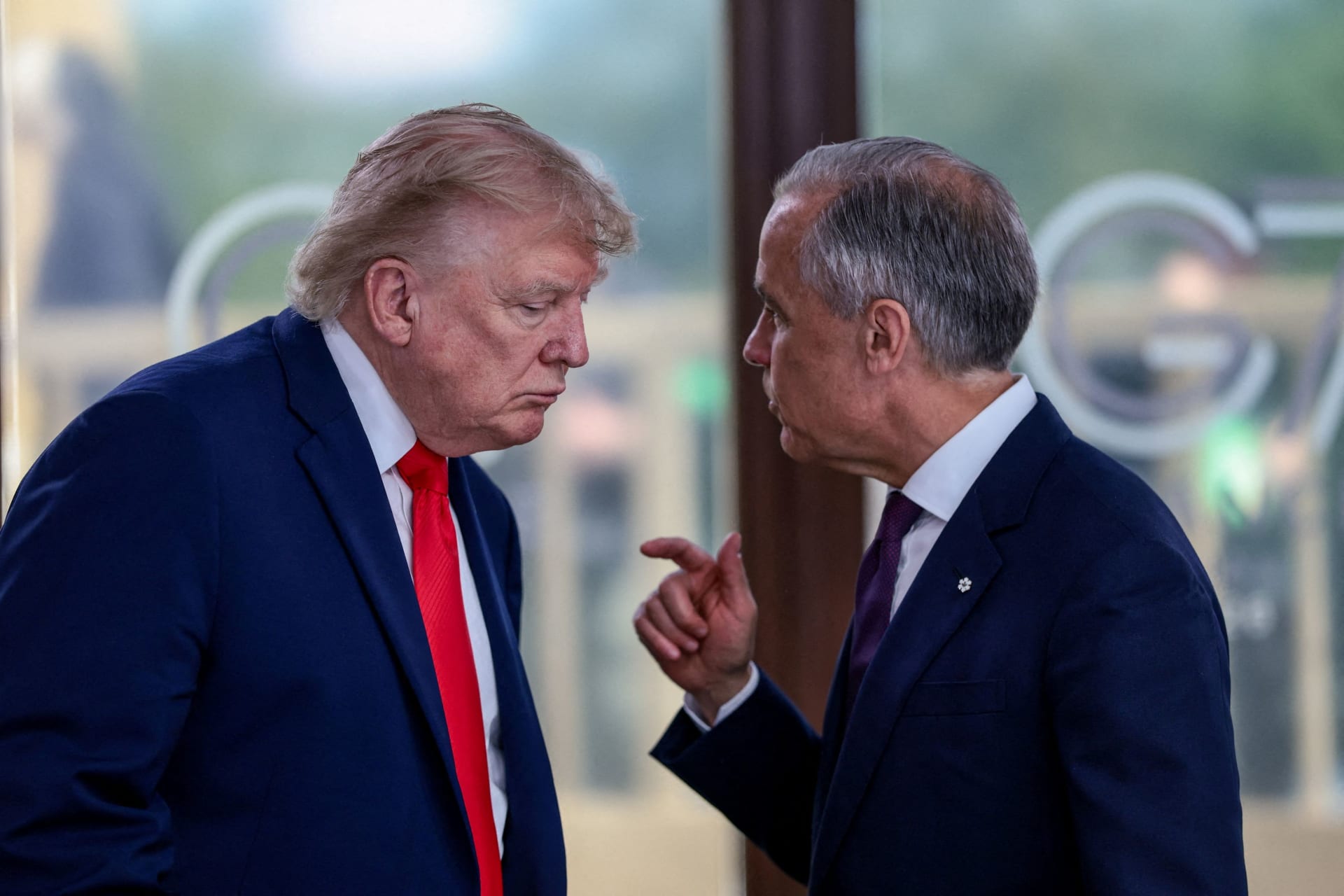 FILE PHOTO: U.S. President Donald Trump speaks with Canadian Prime Minister Mark Carney at a working lunch with leaders of G7 and the Middle East, in Evian-les-Bains, France, June 16, 2026. REUTERS/Evelyn Hockstein/Pool/File Photo