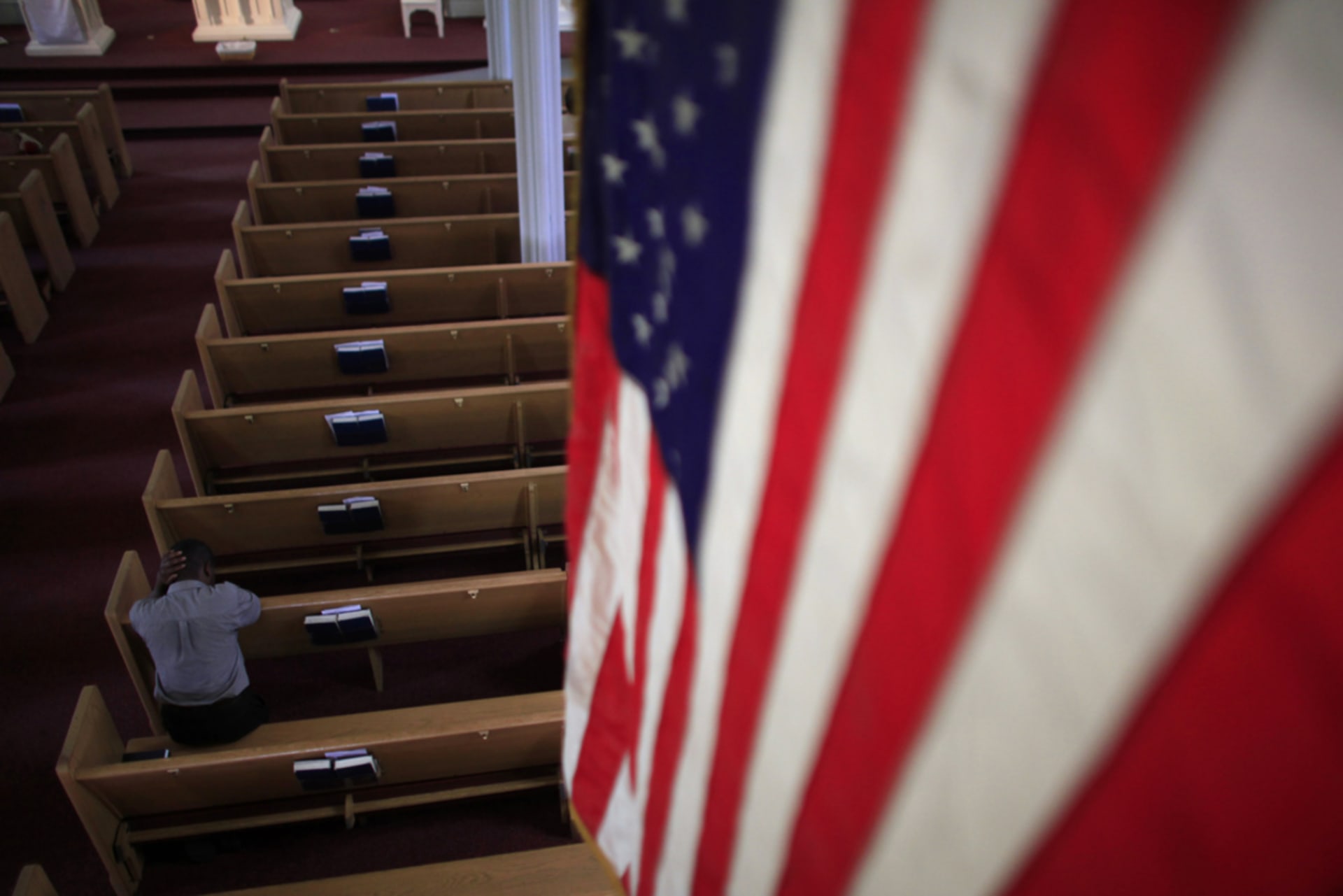 A man attends a Spanish church service at St. Alexius Catholic Church in Beardstown, Illinois