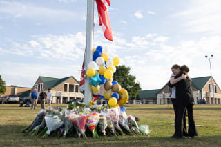<p>Students embrace near a makeshift memorial after a shooting at Apalachee High School in Georgia.</p>
