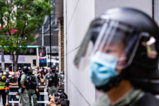 Riot police round up a group of protesters during the