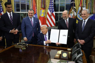 U.S. President Donald Trump displays a signed executive order as (2nd L-R) U.S. Sen. Ted Cruz (R-TX), Commerce Secretary Howard Lutnick and White House artificial intelligence (AI) and crypto czar David Sacks look on in the Oval Office of the White House on December 11, 2025 in Washington, DC.