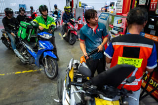 Riders with vehicles queue to fill up fuel at a gas station amid the U.S.-Israeli conflict with Iran, in Bangkok, Thailand, March 26, 2026.