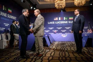Iran's Foreign Minister Abbas Araqchi shakes hands with Pakistan's Prime Minister Shehbaz Sharif next to Pakistan's Chief of Army Staff Field Marshal Asim Munir prior to a quadrilateral meeting between the United States, Iran, Pakistan and Qatar at the Burgenstock luxury hotel complex overlooking Lake Lucerne, Switzerland, on June 21, 2026.