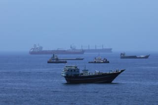 A view of commercial cargo vessels and crude oil tankers are anchored in the Gulf of Oman, off the coast of Muscat, Oman, on June 21, 2026, as they prepare to transit through the critical Strait of Hormuz.