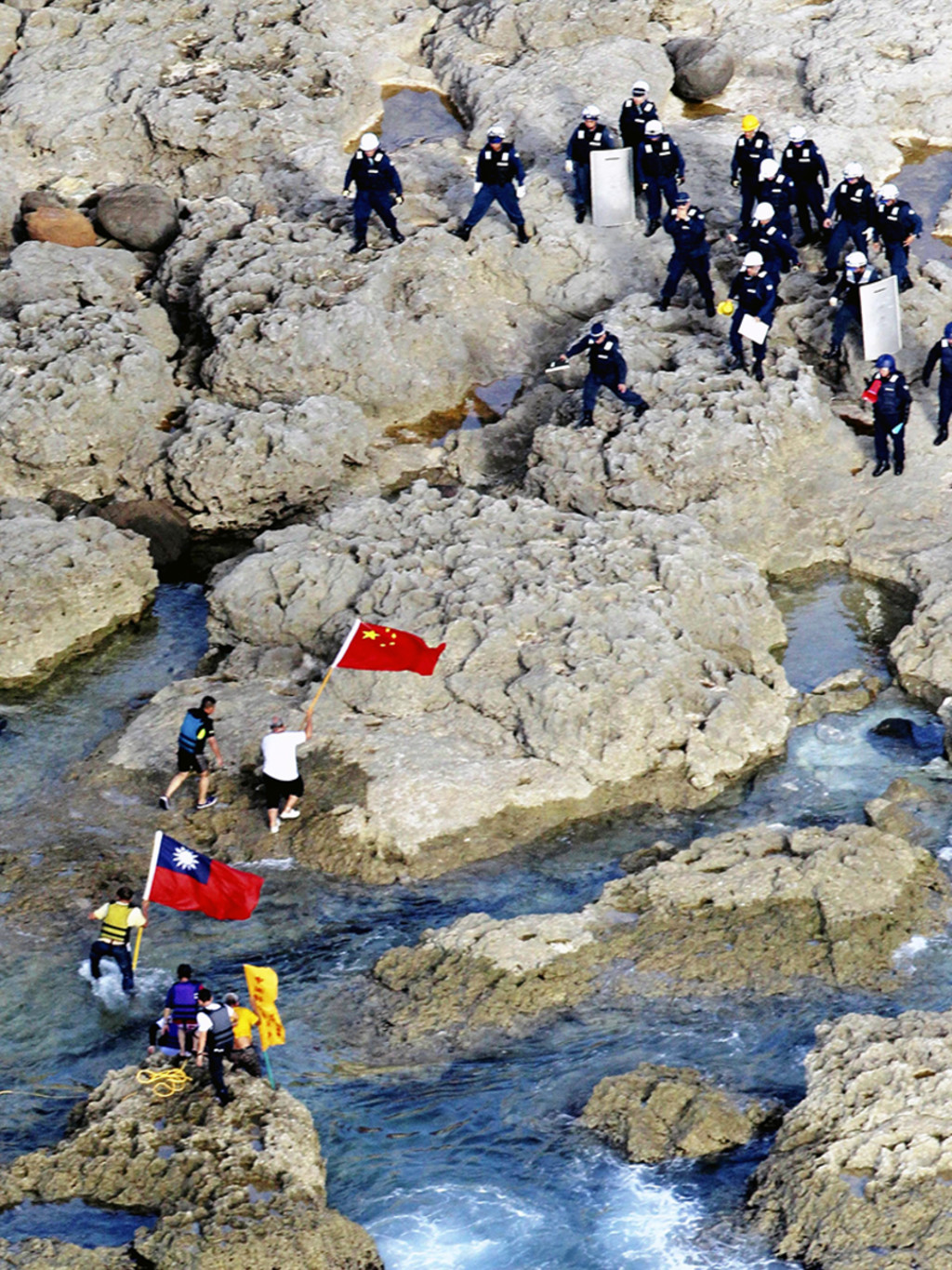 Hong Kong activists land on the Senkaku/Diaoyu Islands with Chinese and Taiwanese flags on August 15, 2012. Yomiuri Shimbun/AP Photo