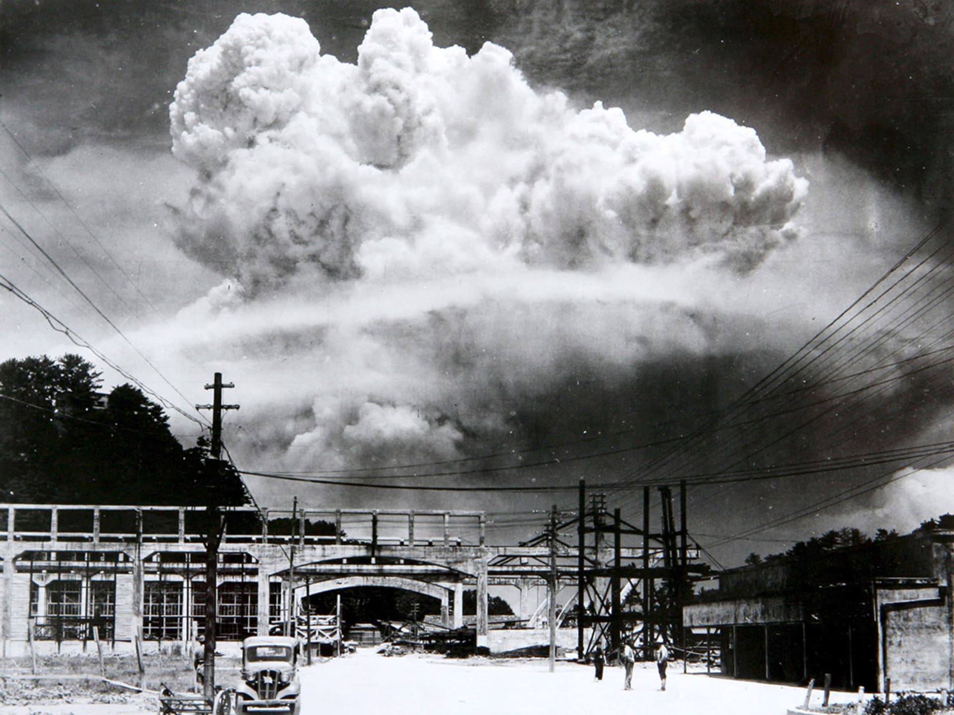 A mushroom cloud from the atomic bomb rises over Nagasaki.