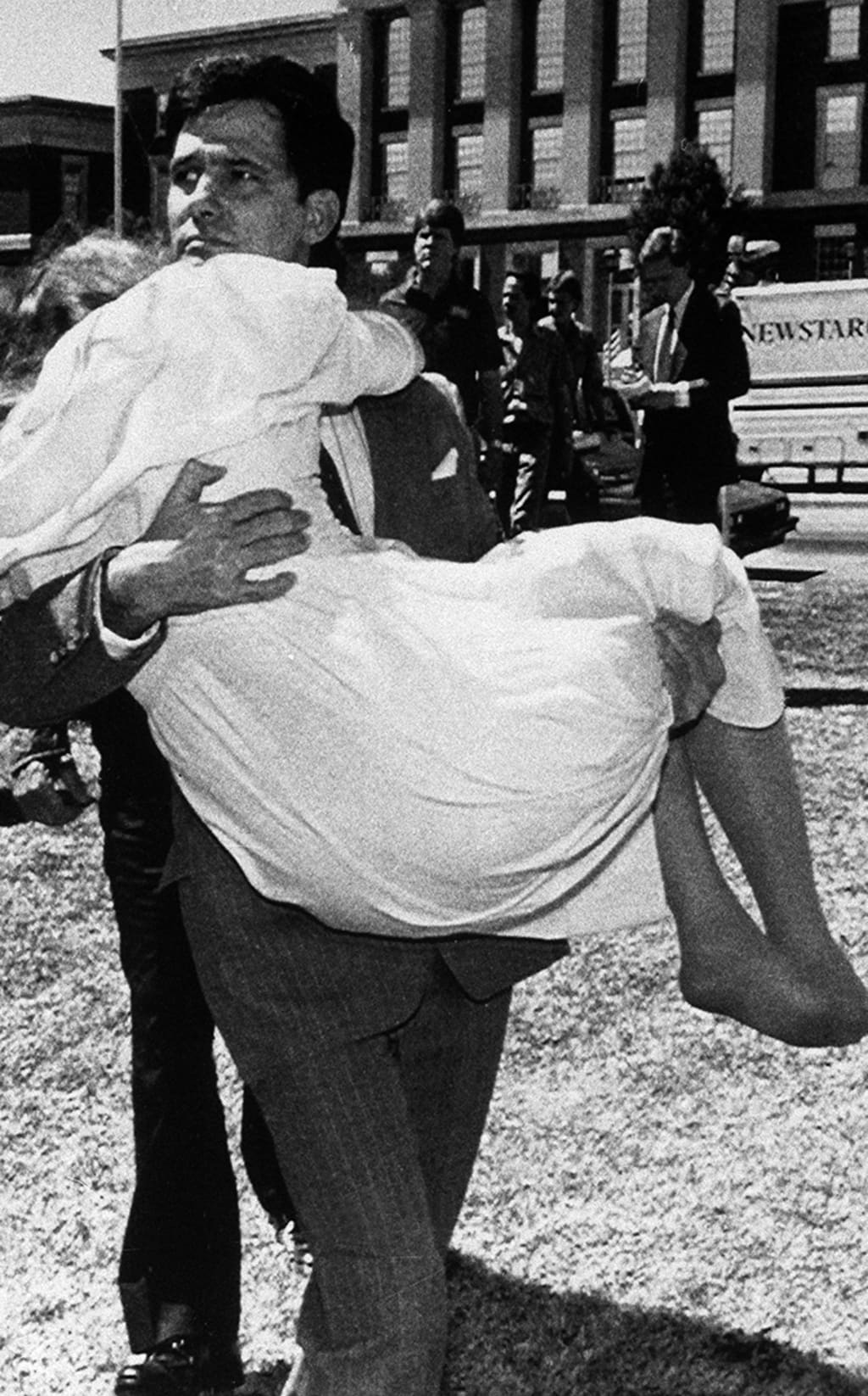 Louis Ray Beam Jr. carries his wife, Sheila, who had fainted, away from the federal courthouse in Fort Smith, Arkansas, after he and twelve other white supremacists are acquitted on sedition charges.