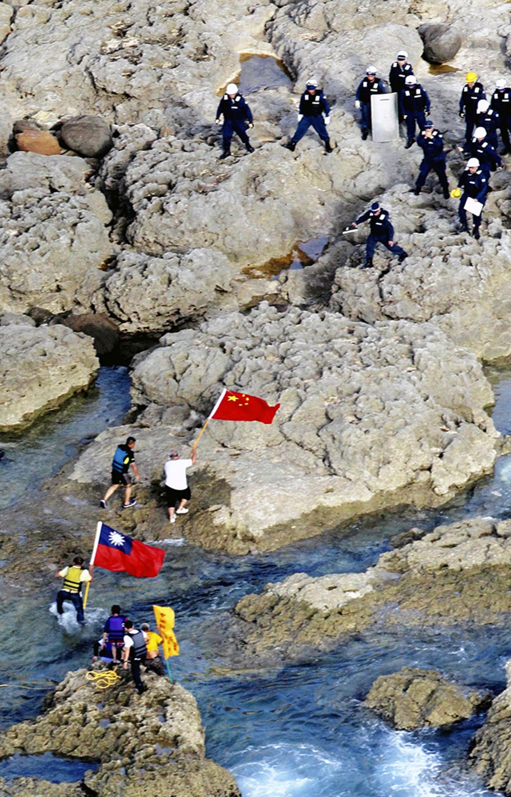 Hong Kong activists land on the Senkaku/Diaoyu Islands with Chinese and Taiwanese flags on August 15, 2012. Yomiuri Shimbun/AP Photo
