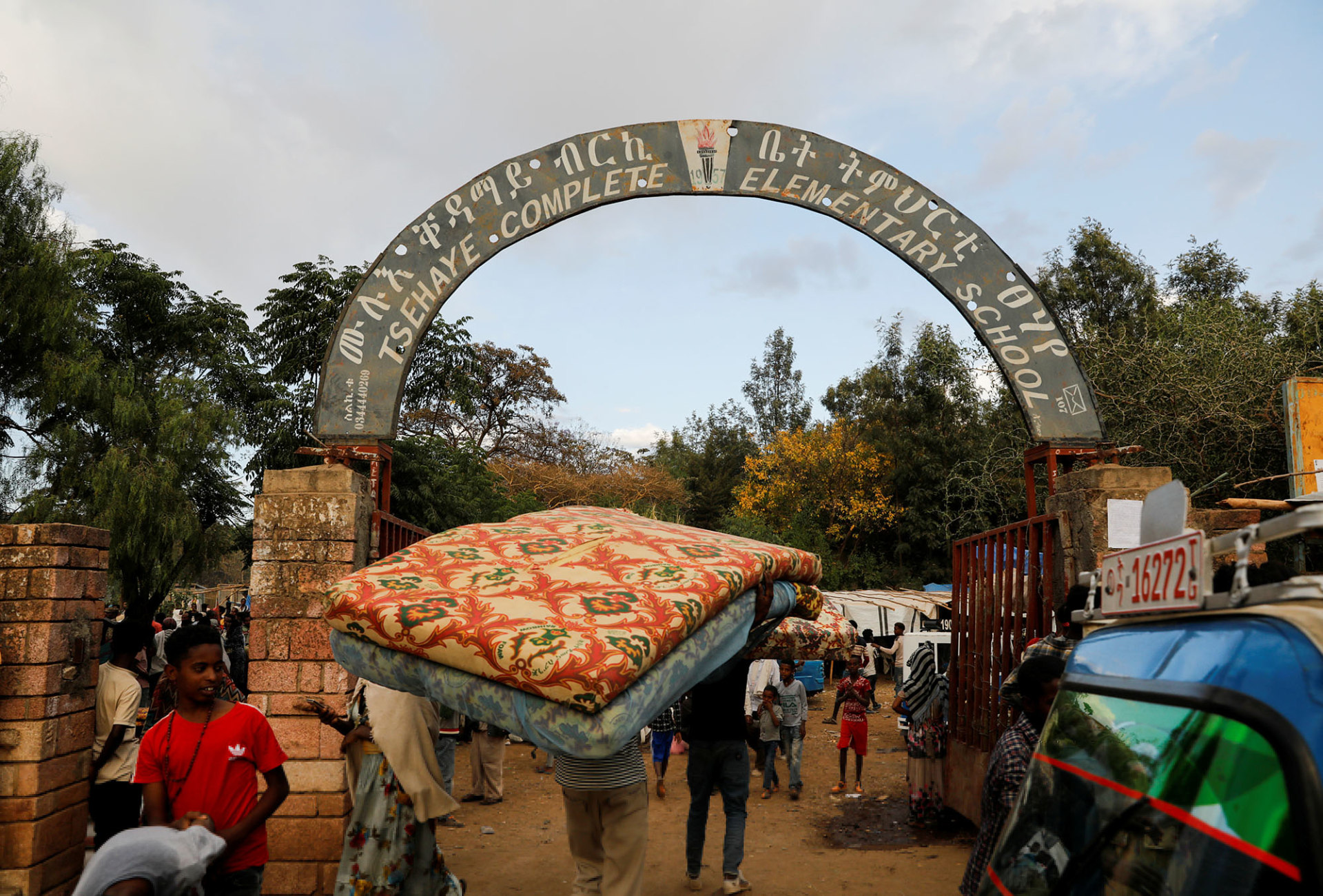 A man carries a mattress into the Tsehaye primary school, which was turned into a temporary shelter for people displaced by conflict, in the town of Shire, Tigray region, Ethiopia on March 15, 2021.