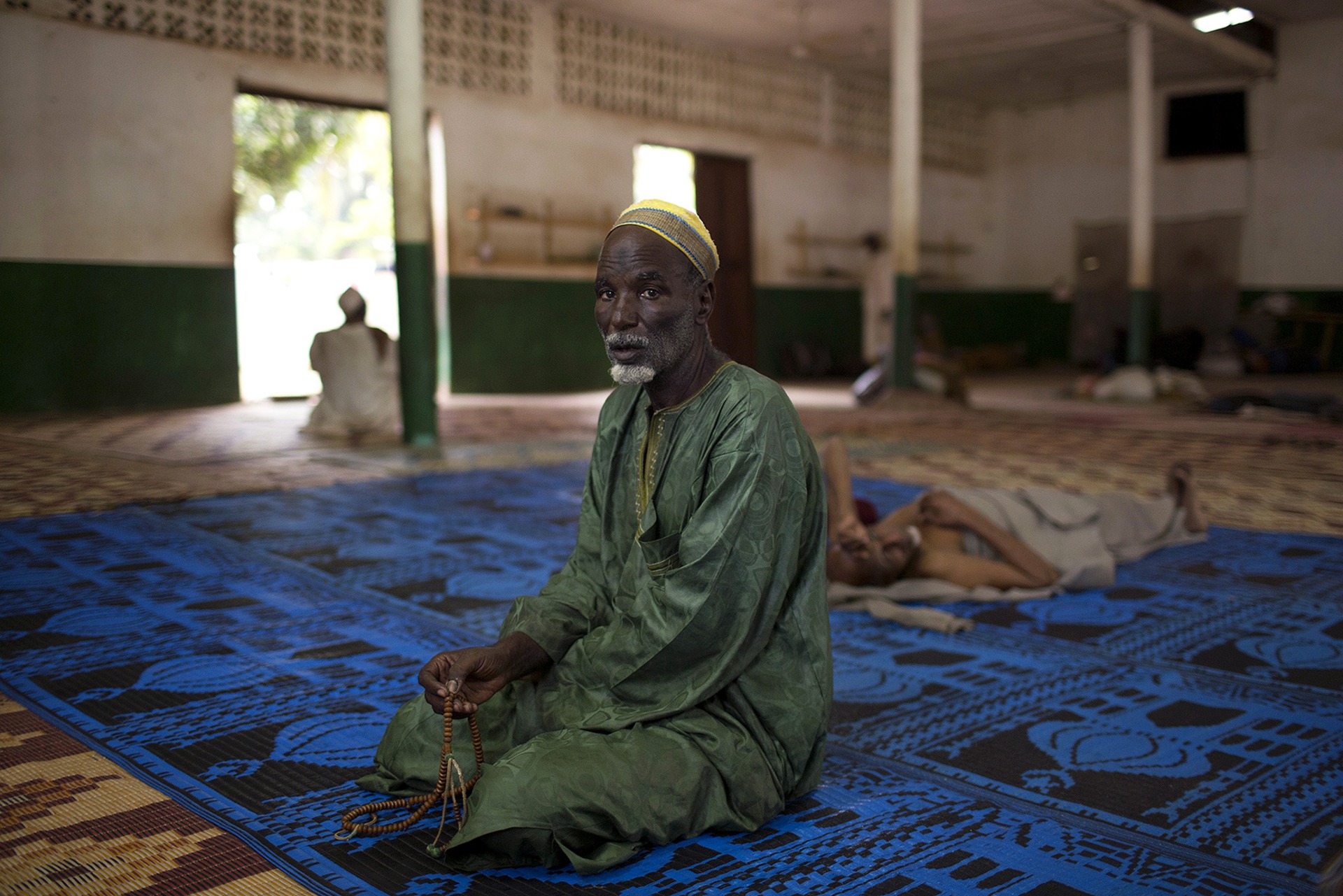 A man prays in a mosque near Kilometer 12 (PK12) where internally displaced Muslims are stranded due to ongoing sectarian violence in the capital of Bangui, Central African Republic on March 19, 2014.