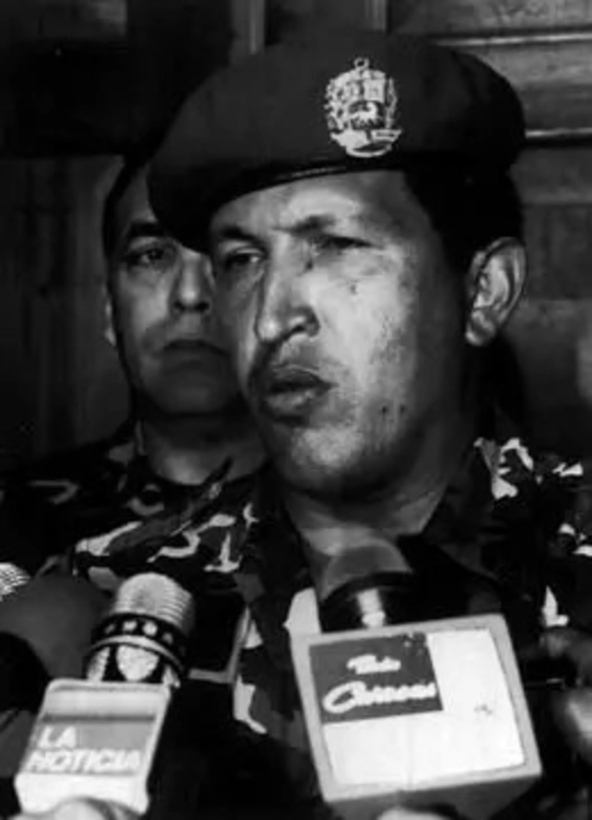 Chavez talks to reporters after surrendering to troops loyal to Perez. 