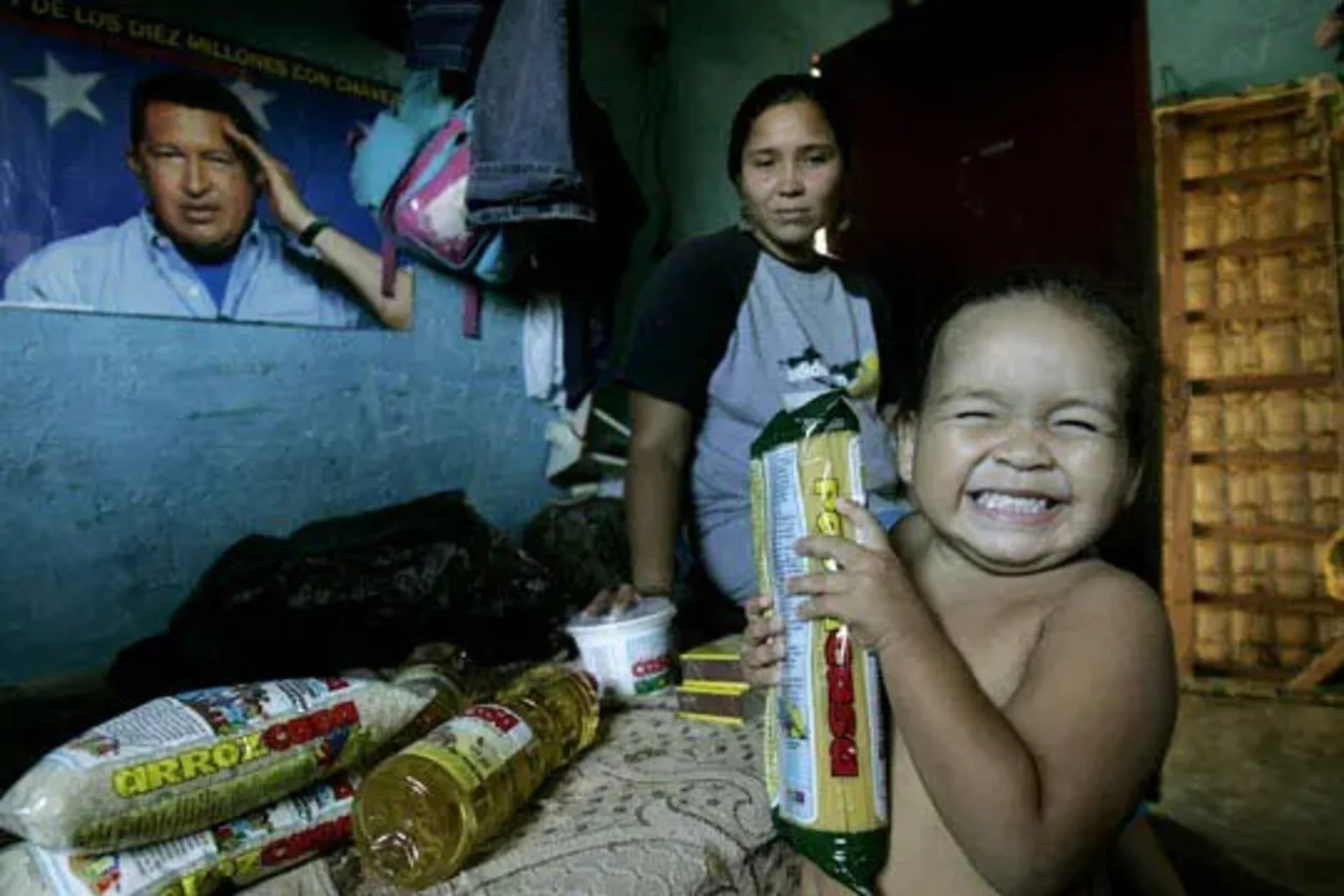 A child displays food from a discount government grocery store. 
