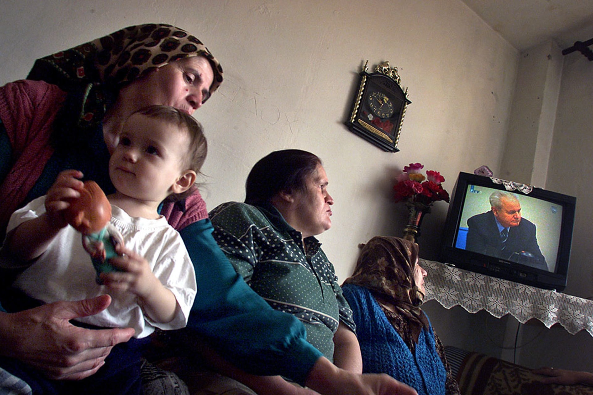 Women at a refugee center in Tuzla, Bosnia, watch television coverage of the trial of former Yugoslav President Slobodan Milosevic.