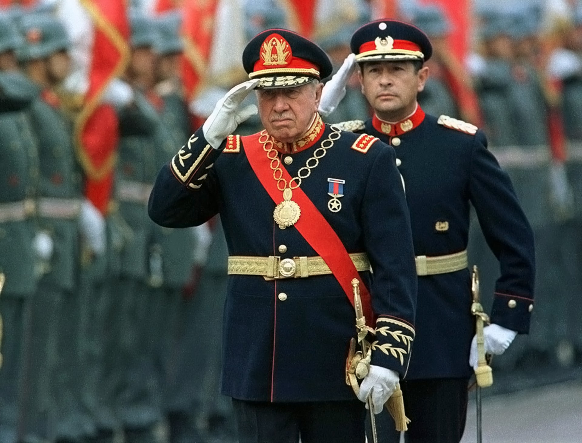Former Chilean dictator Augusto Pinochet salutes troops at the Military School in Santiago.