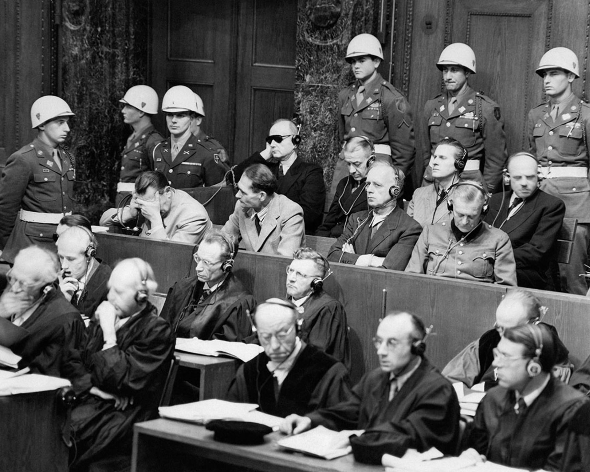 High-ranking Nazi defendants sit in the dock of the courtroom at the Nuremberg war crimes trials.