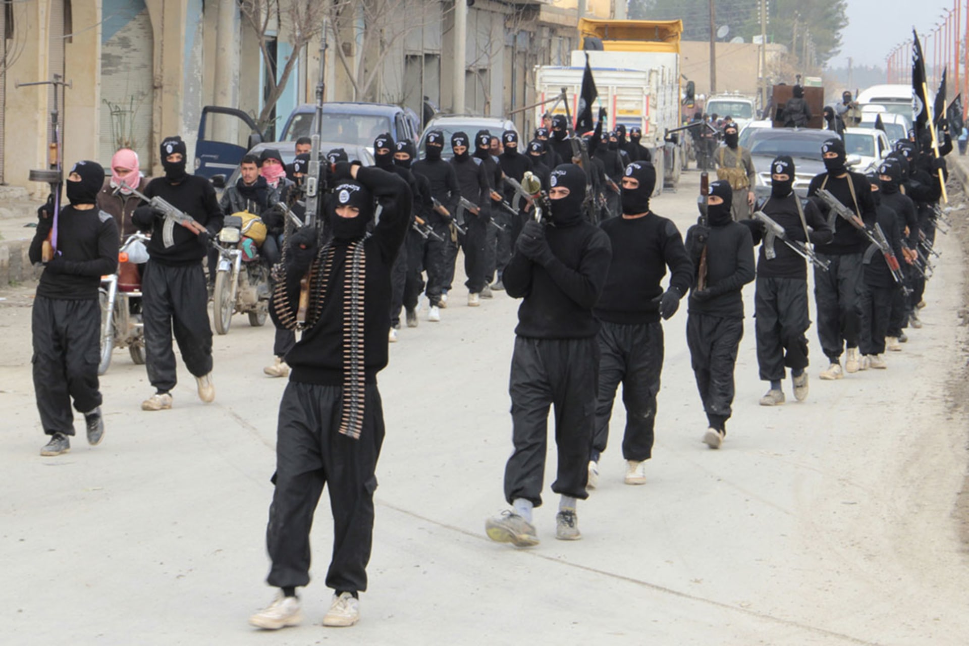 Fighters linked to the Islamic State of Iraq and Syria (ISIS) march during a parade in Tel Abyad, Syria, near the Turkish border. 

