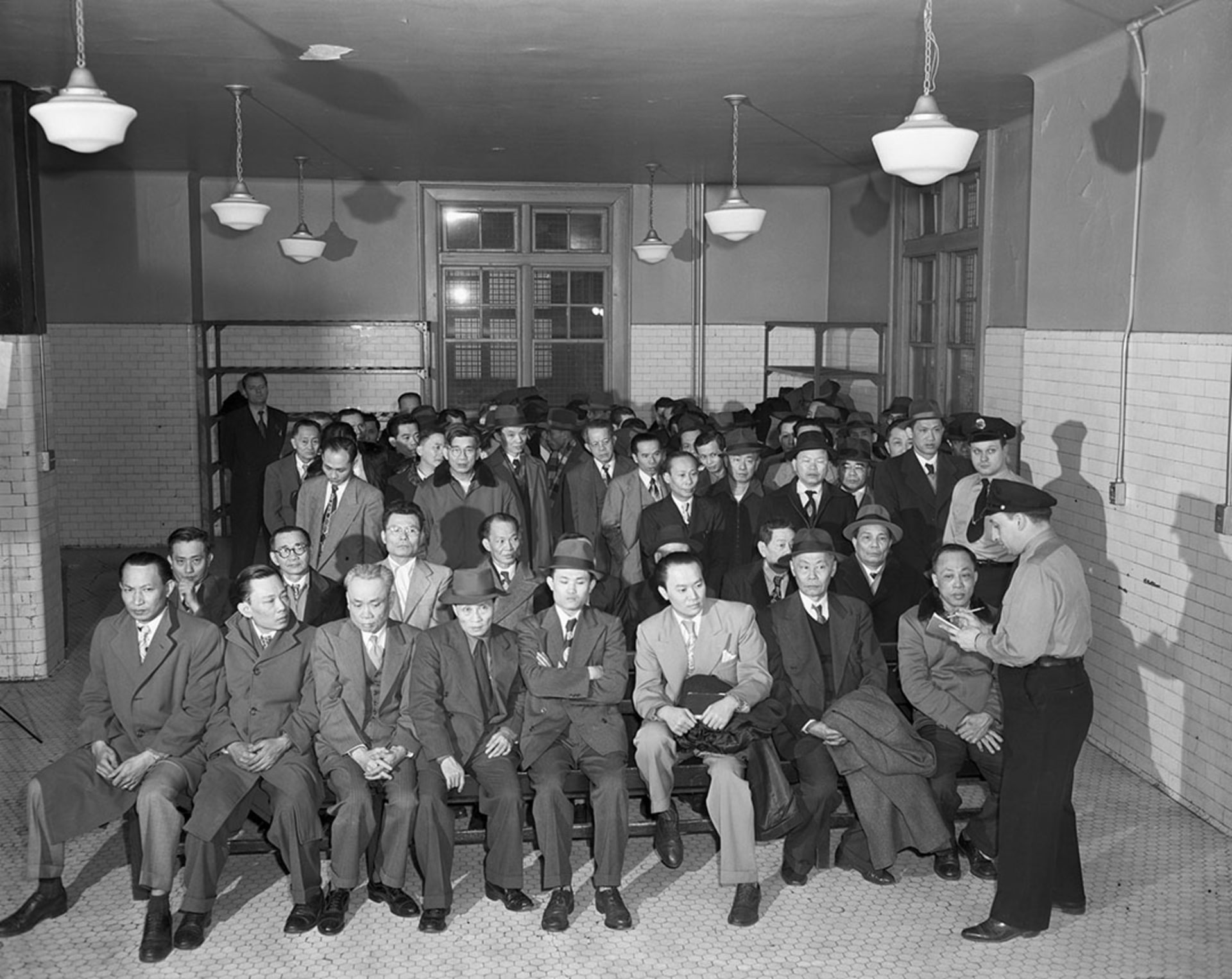 Chinese immigrants undergo an interrogation at Ellis Island. Bettmann/Getty Images