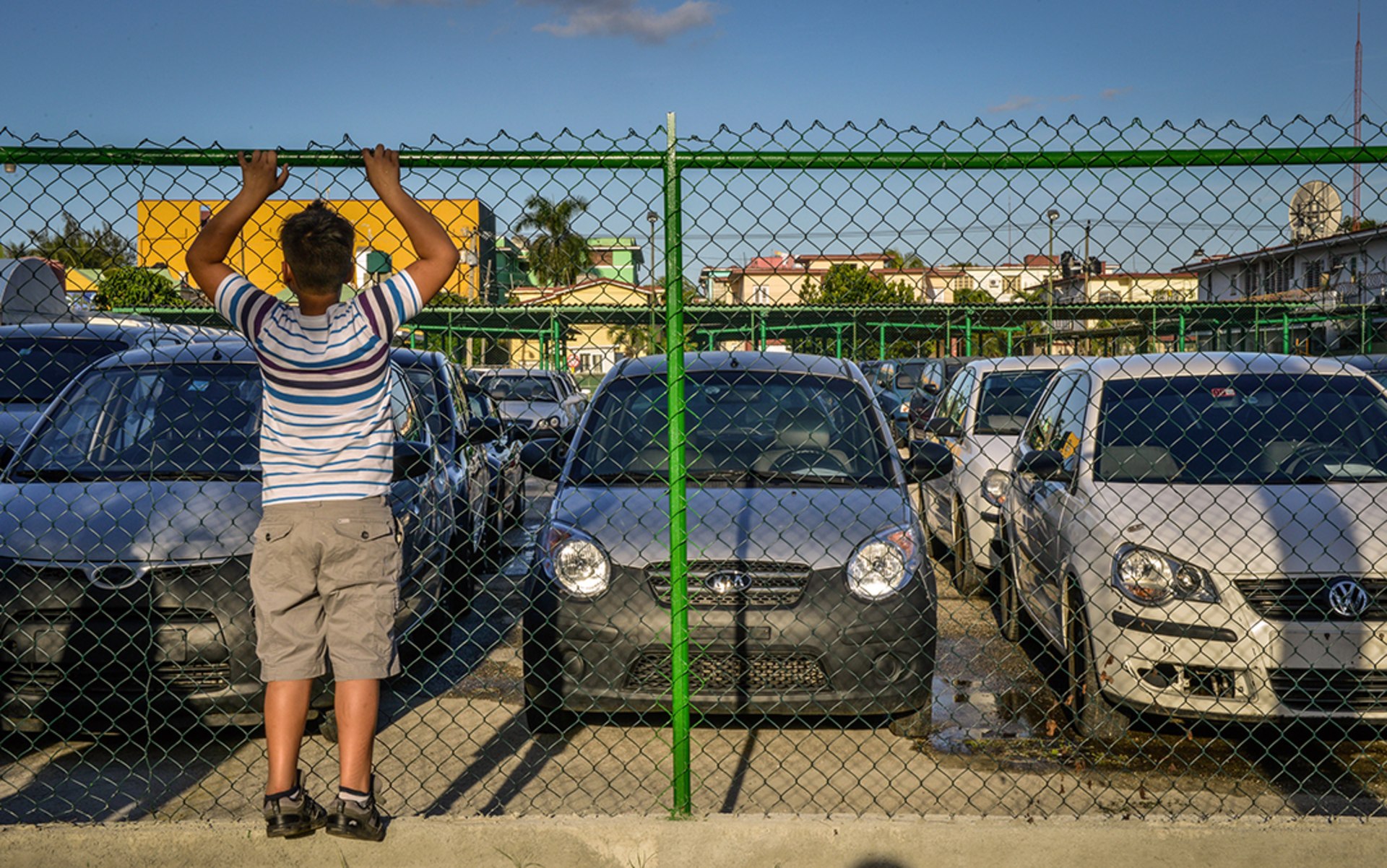 A boy looks at used cars for sale in Havana in January 2014.
