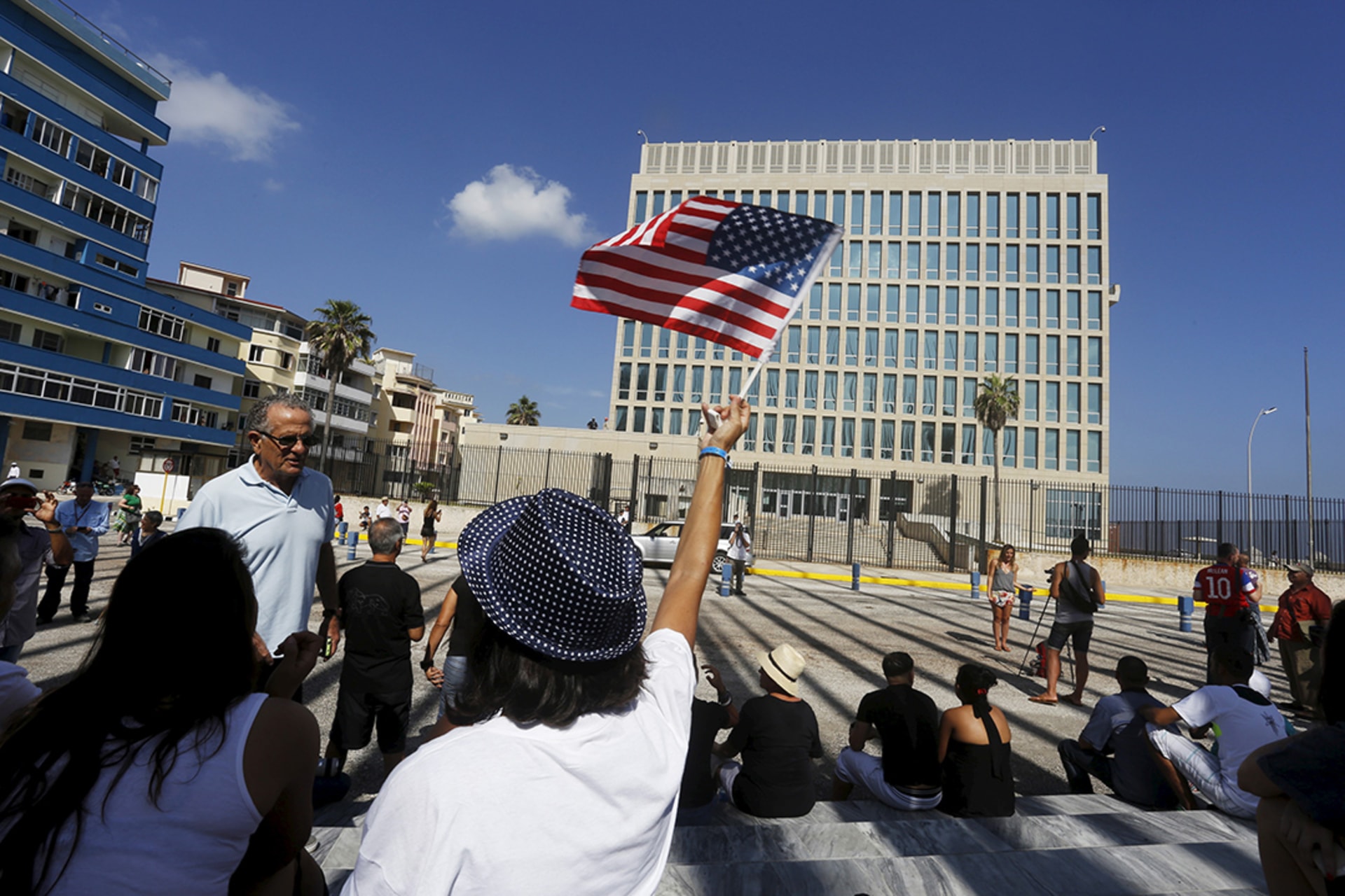 A woman waves a U.S. flag near the reestablished embassy in Havana, July 20, 2015.