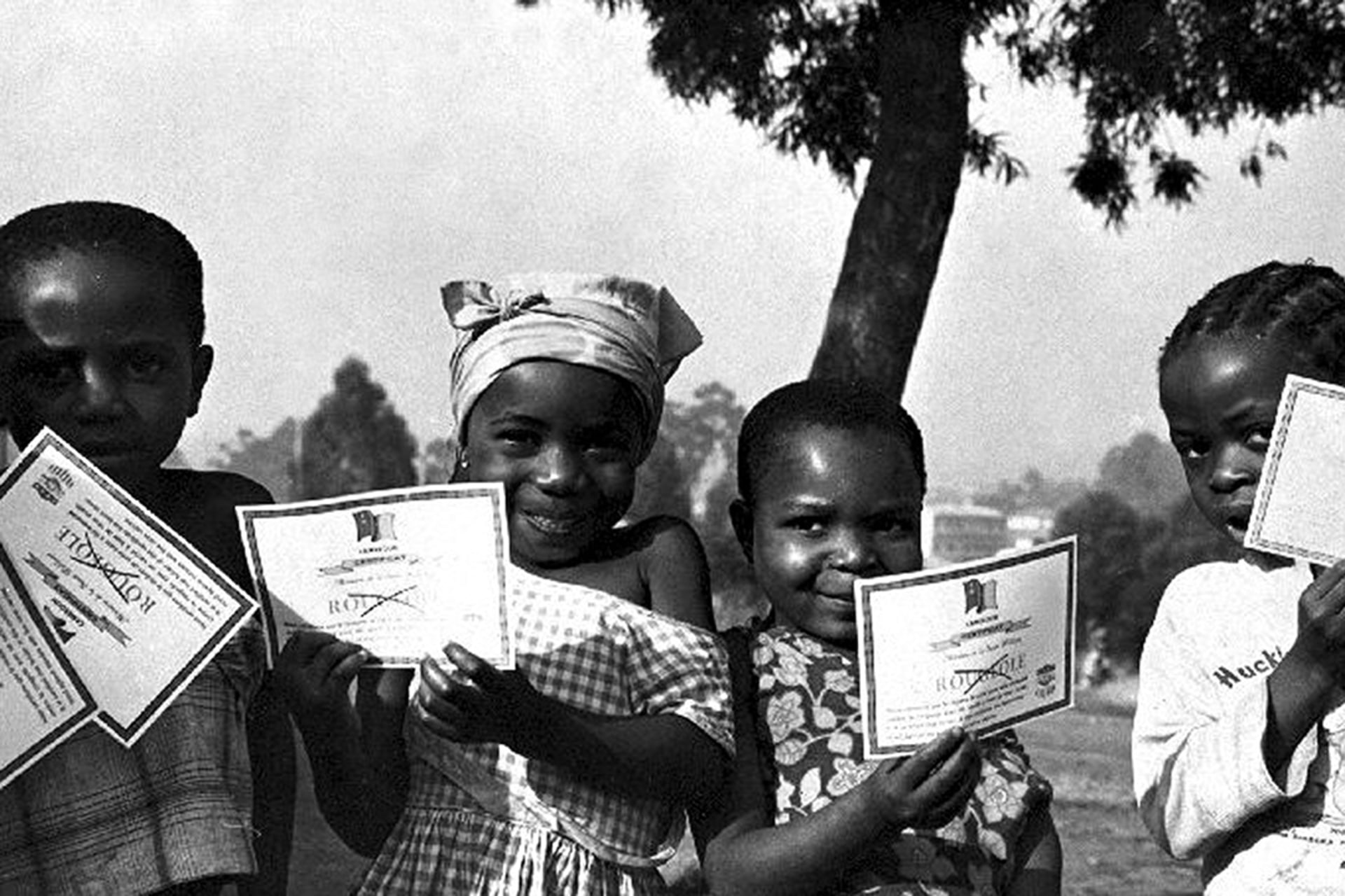 Children stand with their smallpox vaccination certificates in Cameroon in January 1975. Smith Collection/Gado/Getty Images
