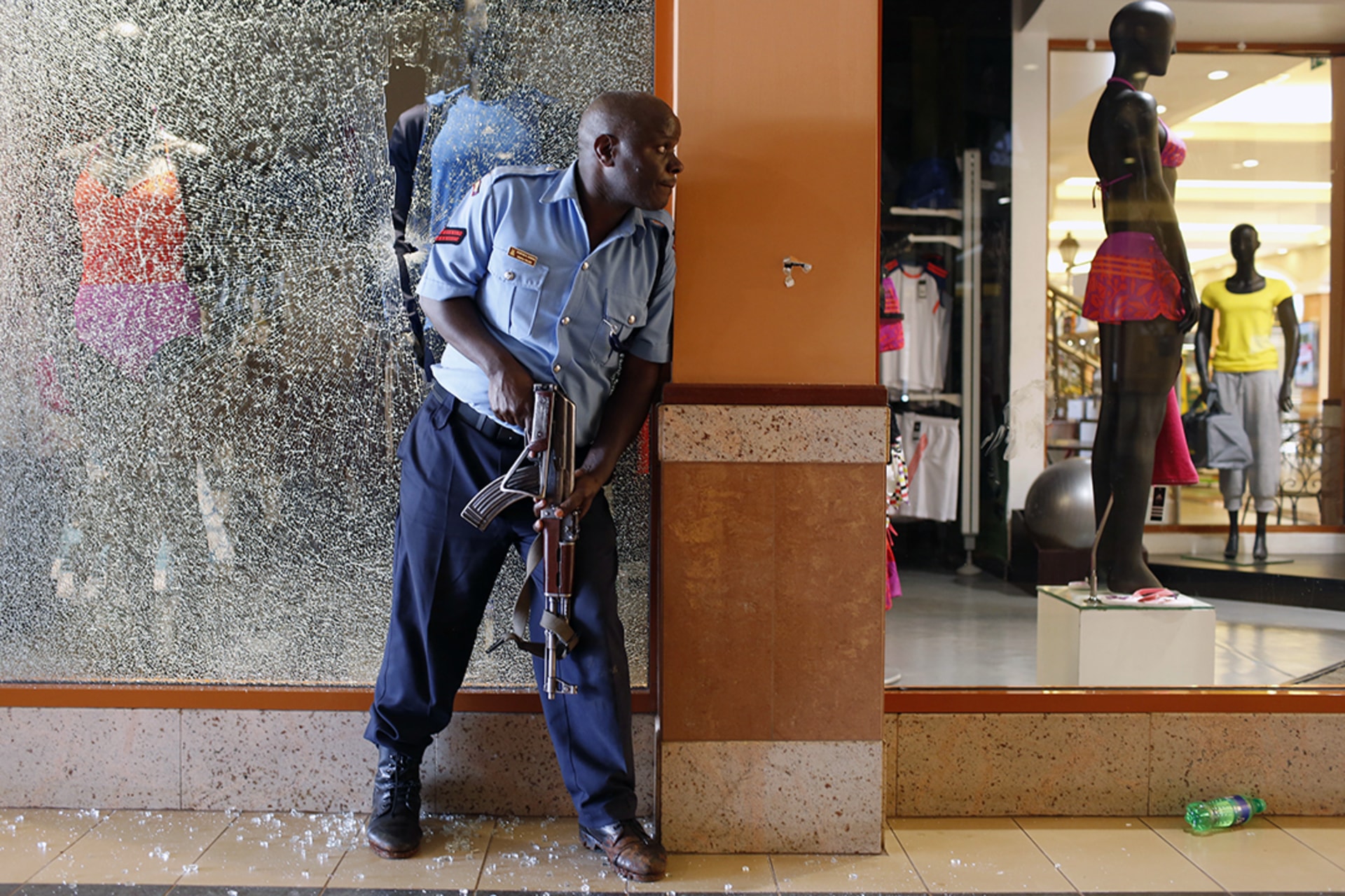 A police officer secures an area inside the Westgate Shopping Center, where al-Shabaab gunmen went on a shooting spree. Siegfried Modola/Reuters