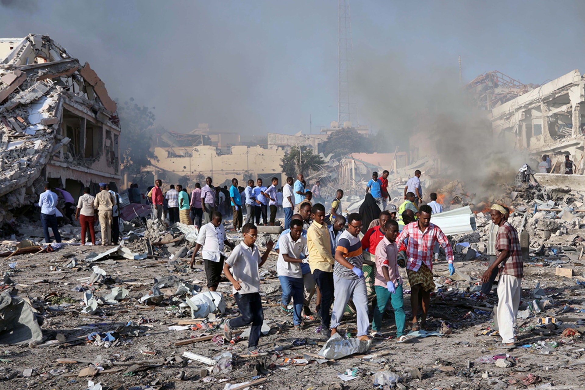Civilians carry the dead body of an unidentified man from the scene of an explosion in Mogadishu. Feisal Omar/Reuters