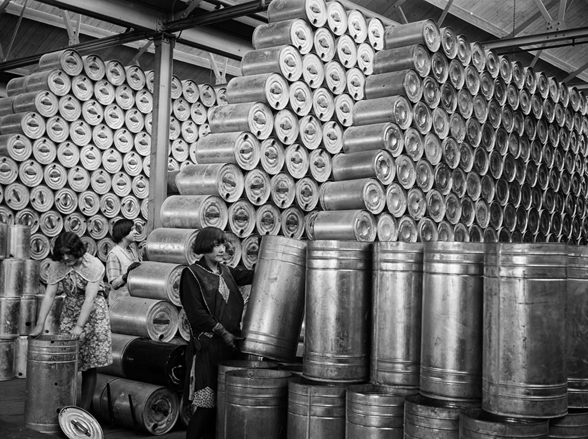 Workers at a factory stacking drums of oil in a warehouse, February 1930. 
