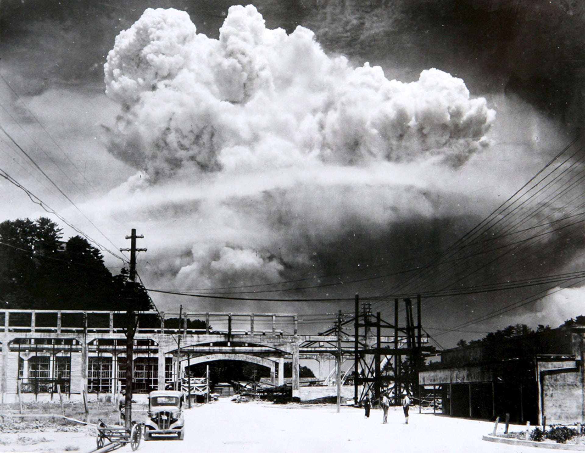 A mushroom cloud from the atomic bomb rises over Nagasaki.