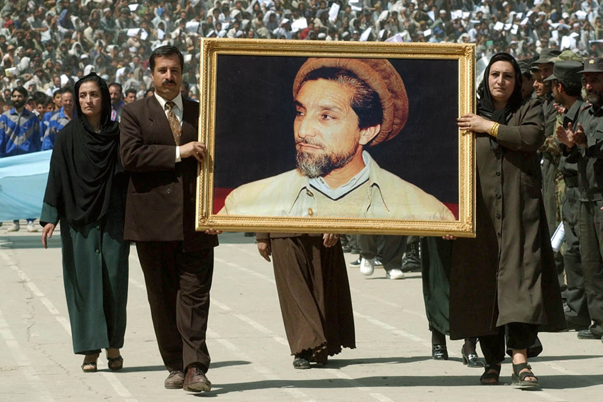 Afghans carry a picture of Massoud in Kabul, Afghanistan.