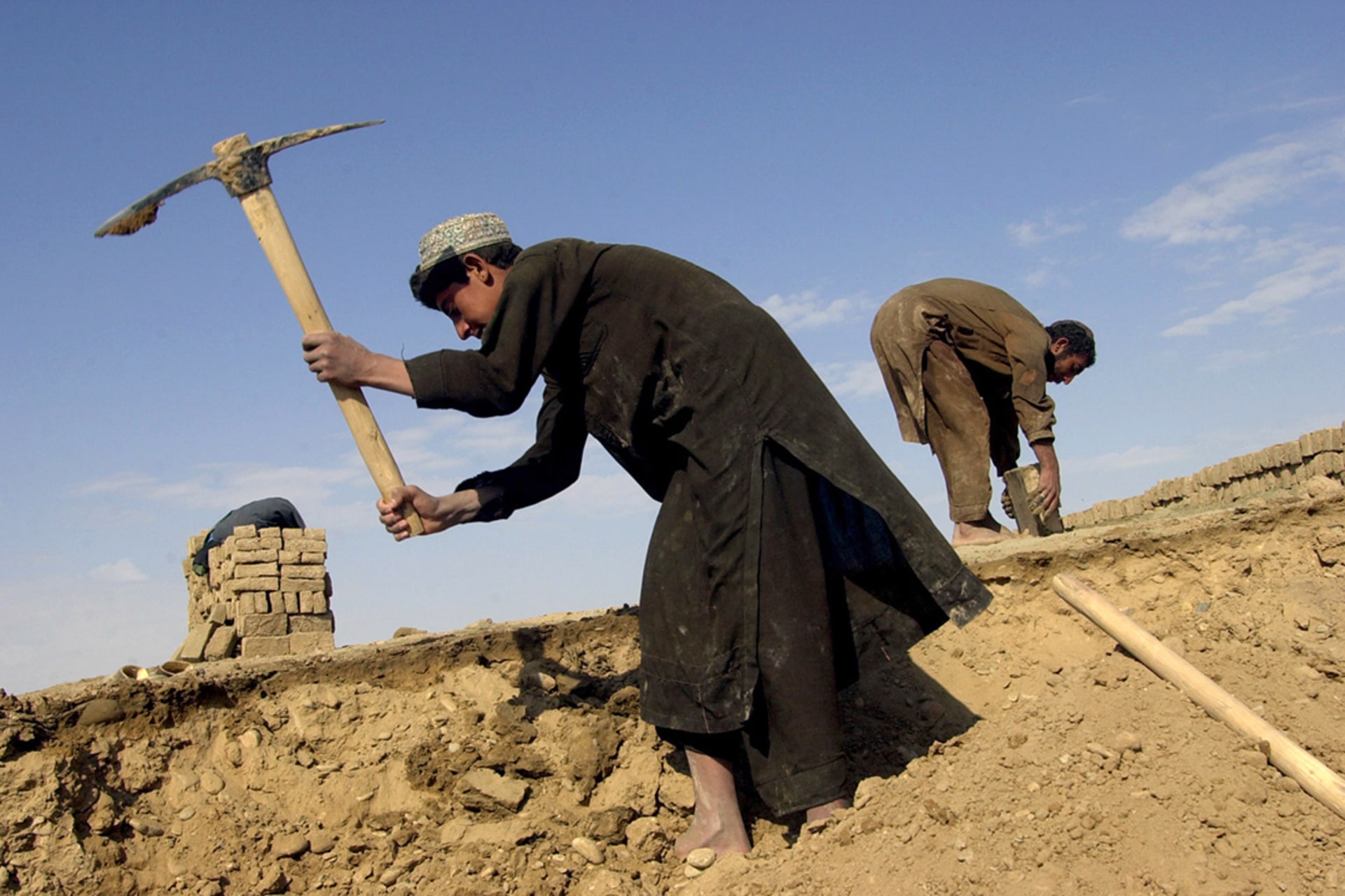 Former refugees make bricks for the reconstruction of their houses in Aynar village, Afghanistan.