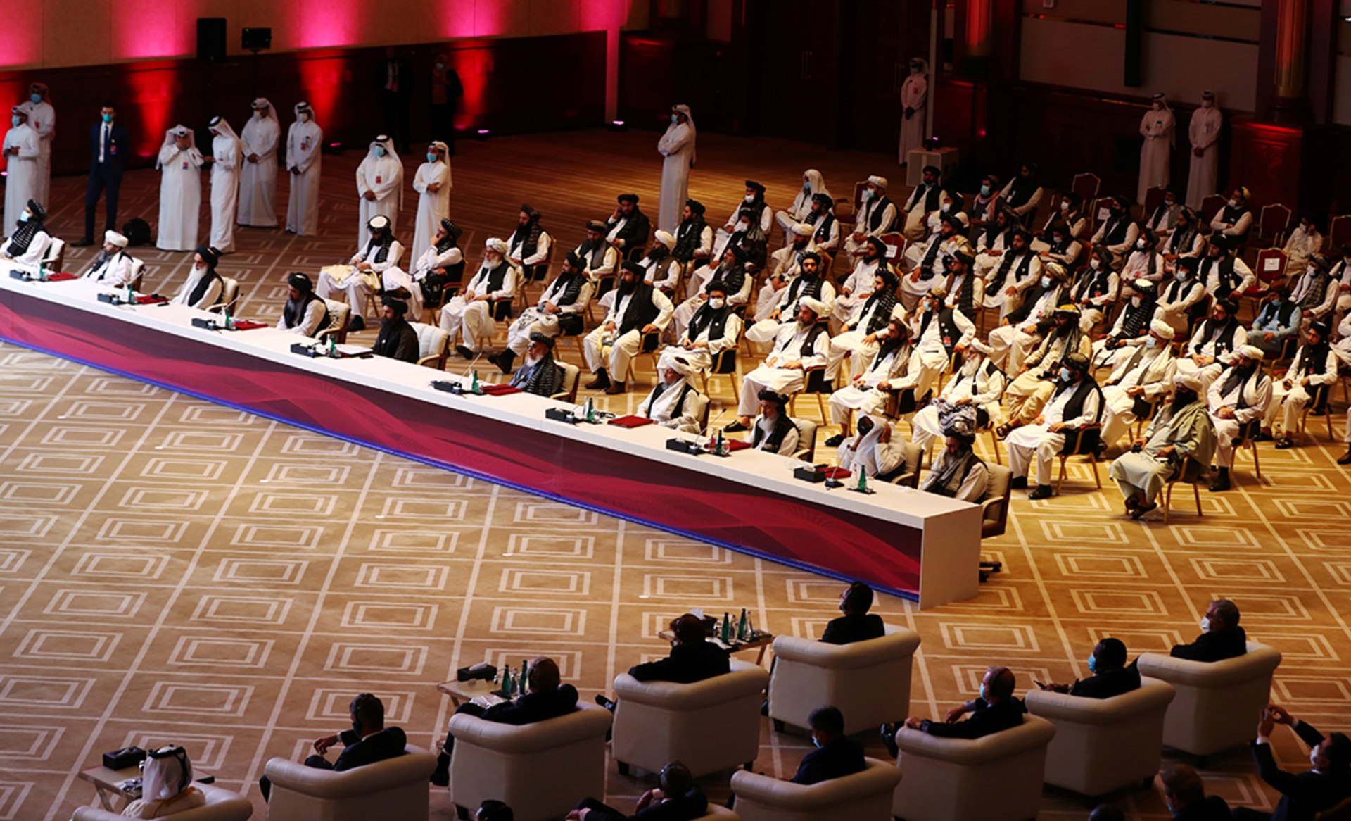 Delegates from the Afghan government and the Taliban attend talks in Doha.