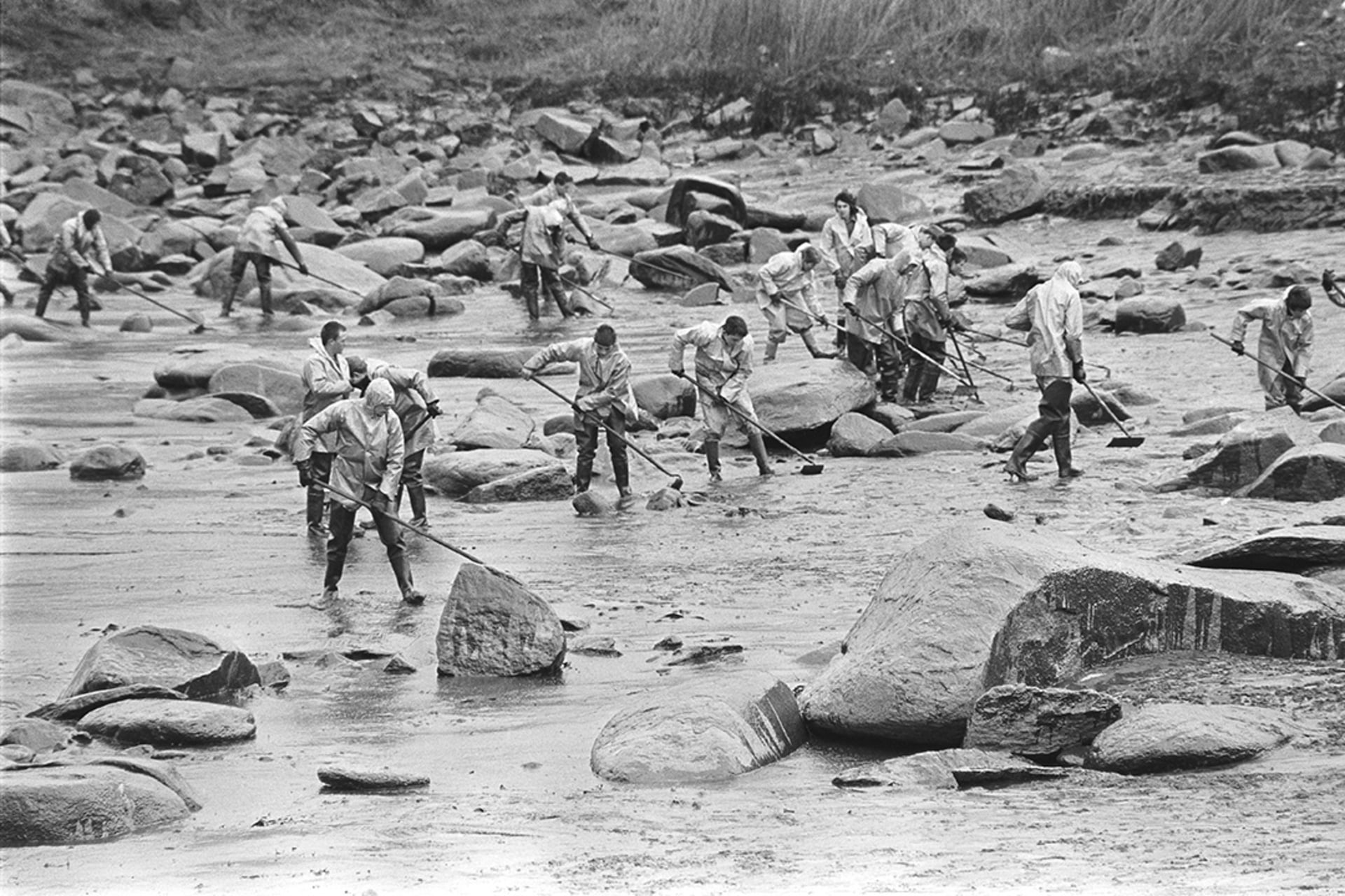 Workers clean a beach along the coast of Brittany, France, after an oil tanker ran aground in 1978.  
