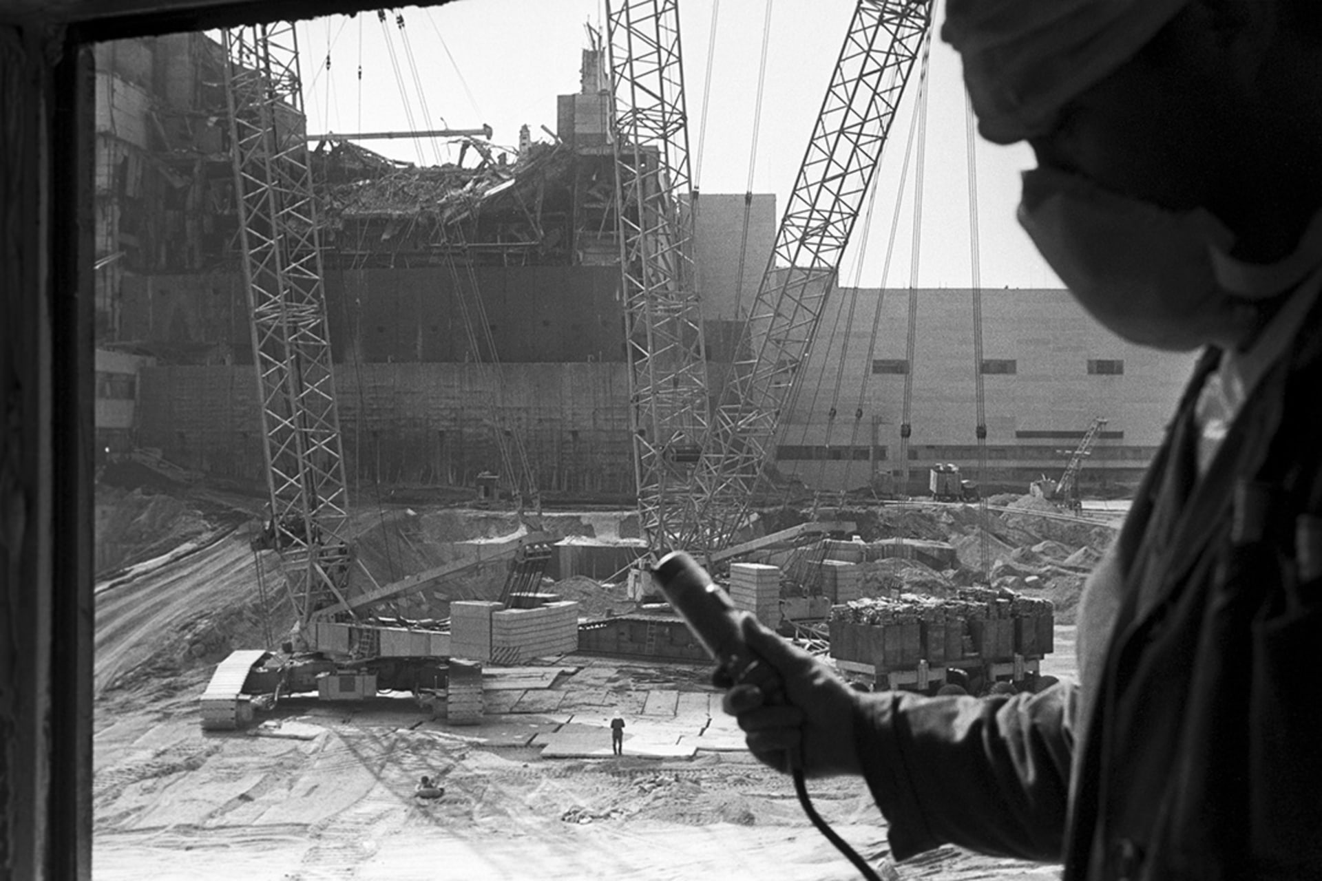 A worker measures radiation levels following an explosion at the Chernobyl Nuclear Power Plant. 
