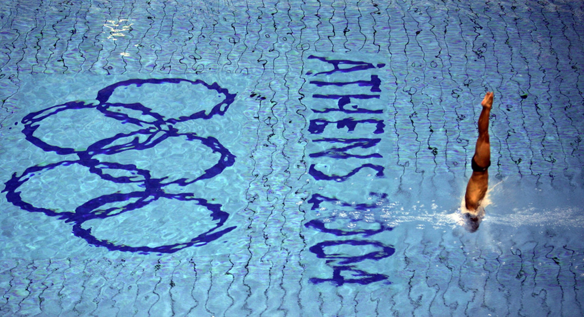 An athlete dives during a training session in the Olympic aquatic center in Athens ahead of the start of the 2004 Olympic Games. 
