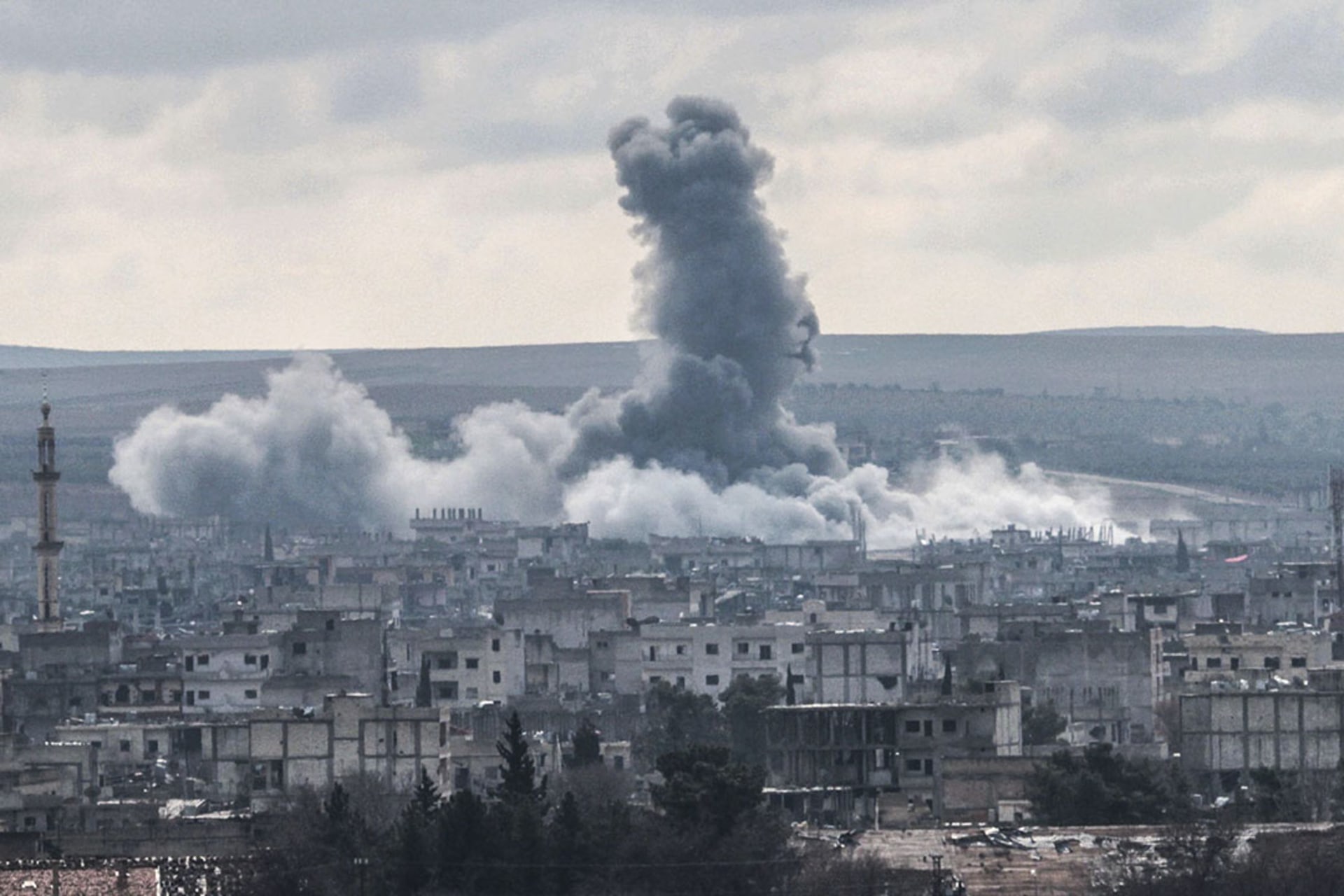 Smoke rises from the Syrian border town of Kobani following U.S.-led coalition air strikes against Islamic State targets in January 2015.