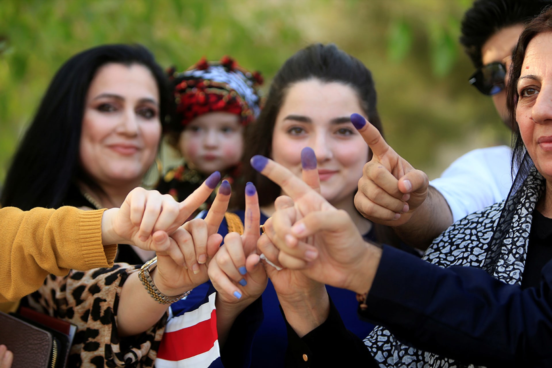 Women in Sulaymaniyah show their fingers after voting in the Iraq referendum.
