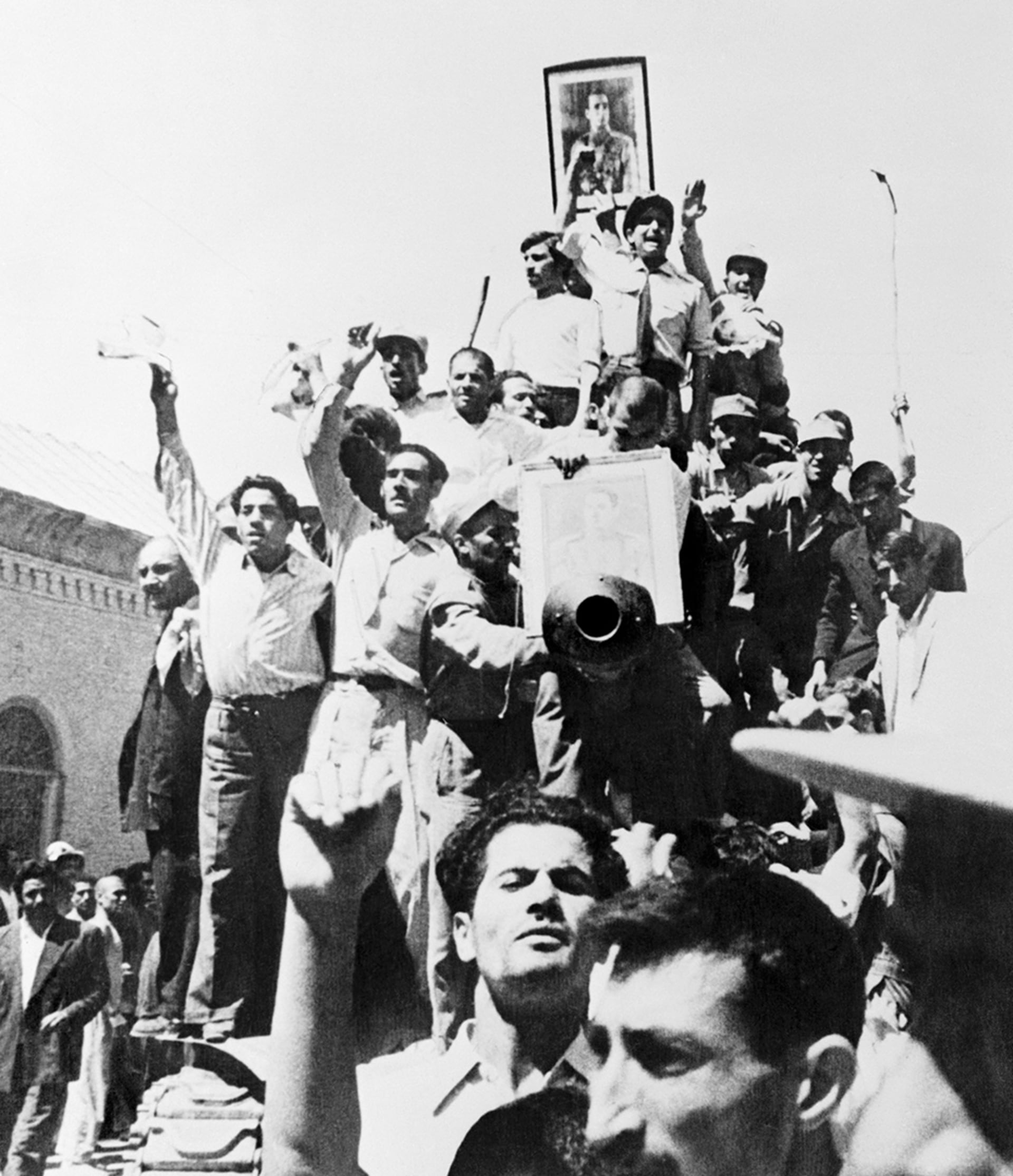 Iranians carry a portrait of the shah through the streets of Tehran after the overthrow of Prime Minister Mohammed Mossadeq.