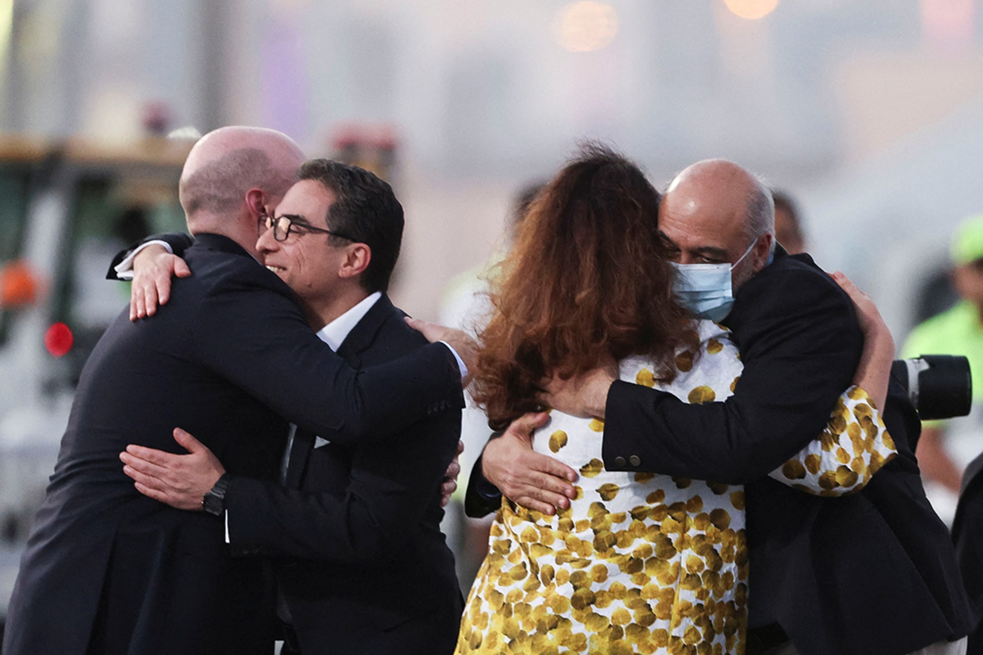 Formerly detained Iranian American dual citizens Siamak Namazi and Morad Tahbaz are greeted as they disembark in Doha, Qatar, before traveling on to the United States.