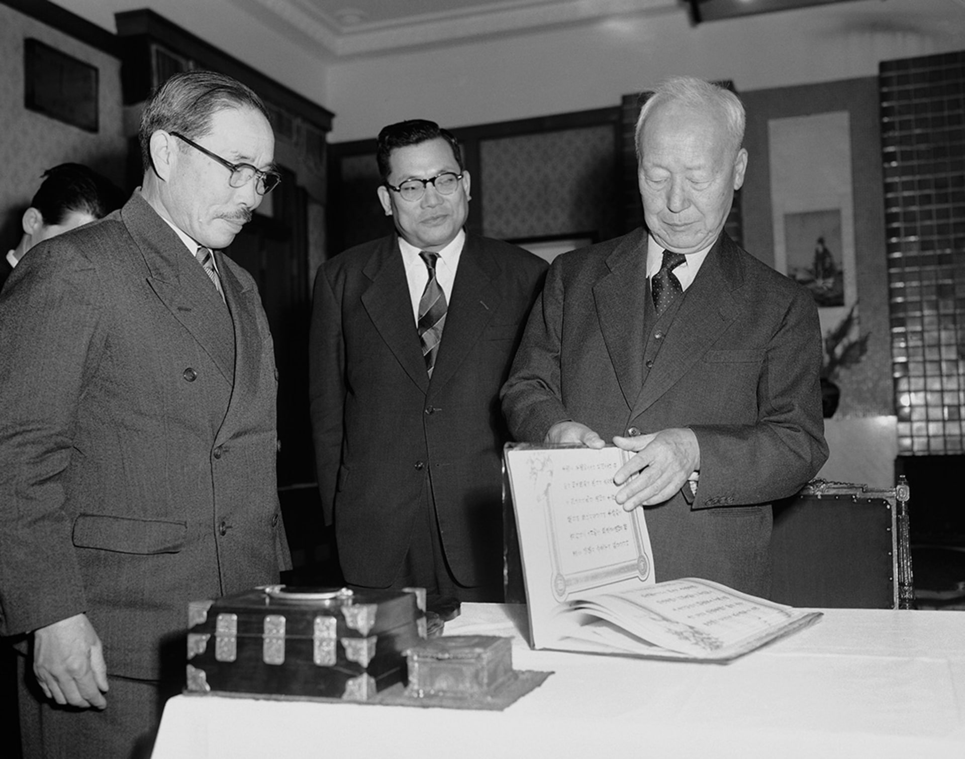 South Korean President Rhee Syngman leafs through the mutual defense treaty between the United States and Republic of Korea on January 29, 1954. George Sweers/AP Photo