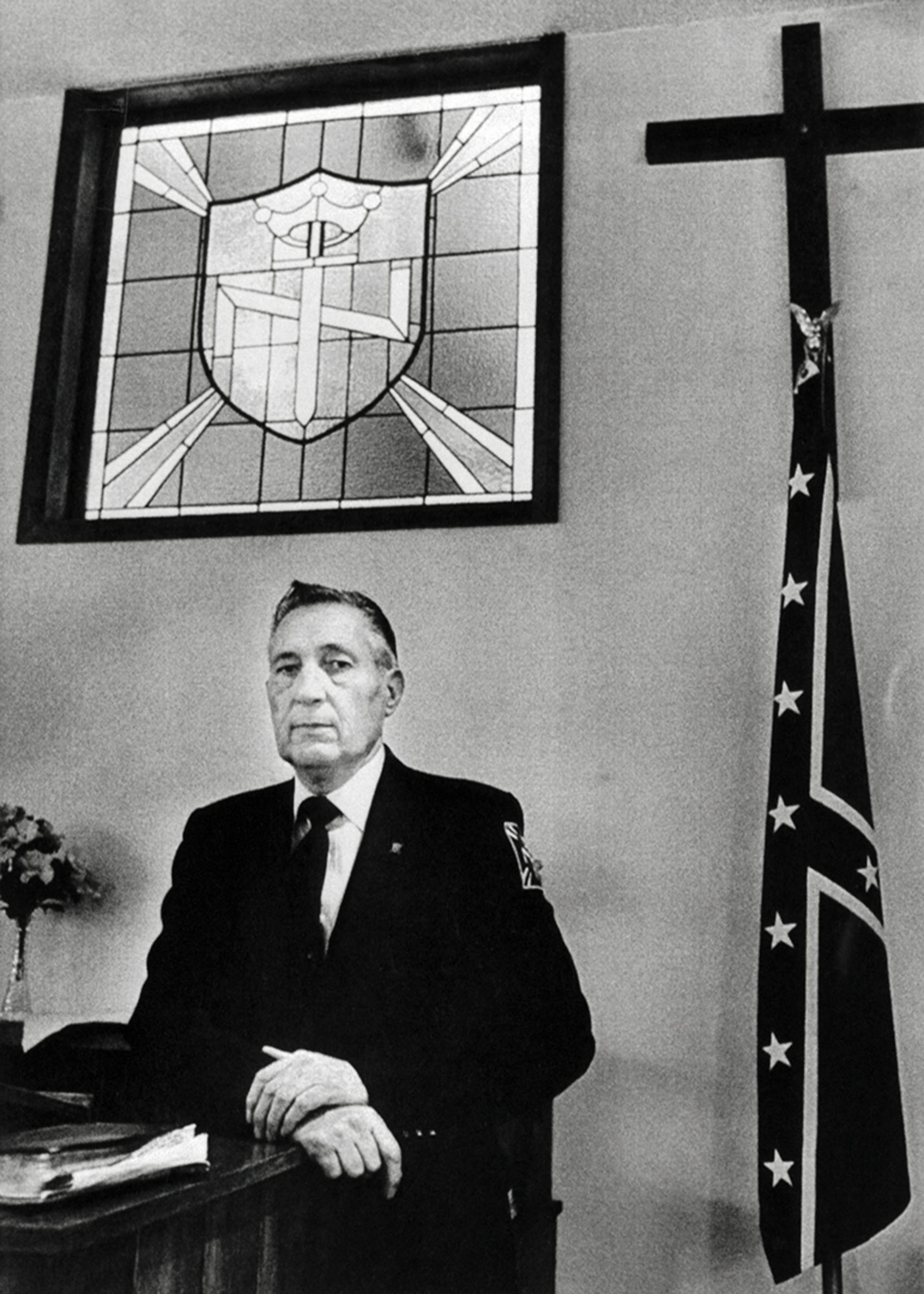 Reverend Richard Butler poses in his church at the headquarters of the Aryan Nations neo-nazi organization, in northern Idaho.