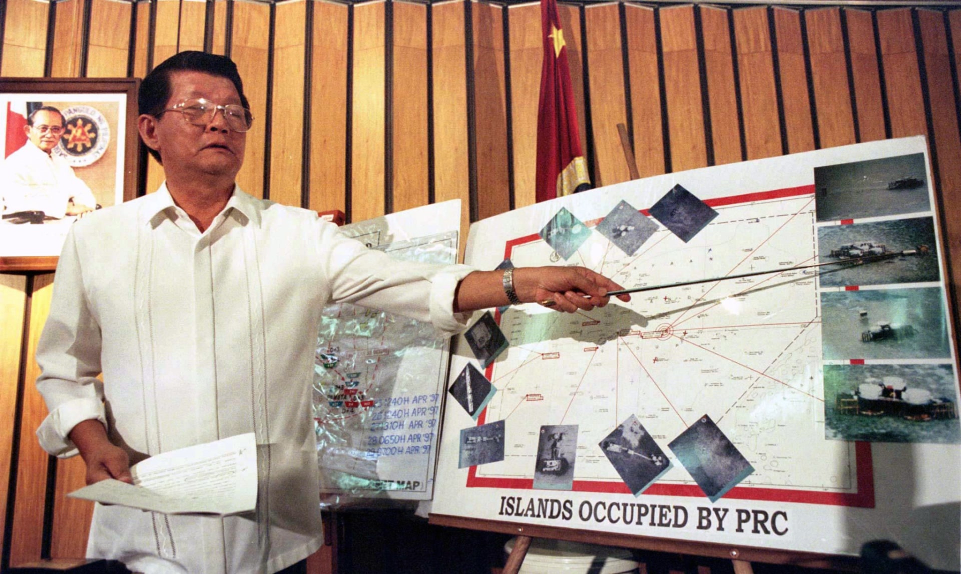 Former Philippine Secretary of National Defense Renato de Villa points out a Chinese-built structure in the disputed Spratly Islands. Reuters