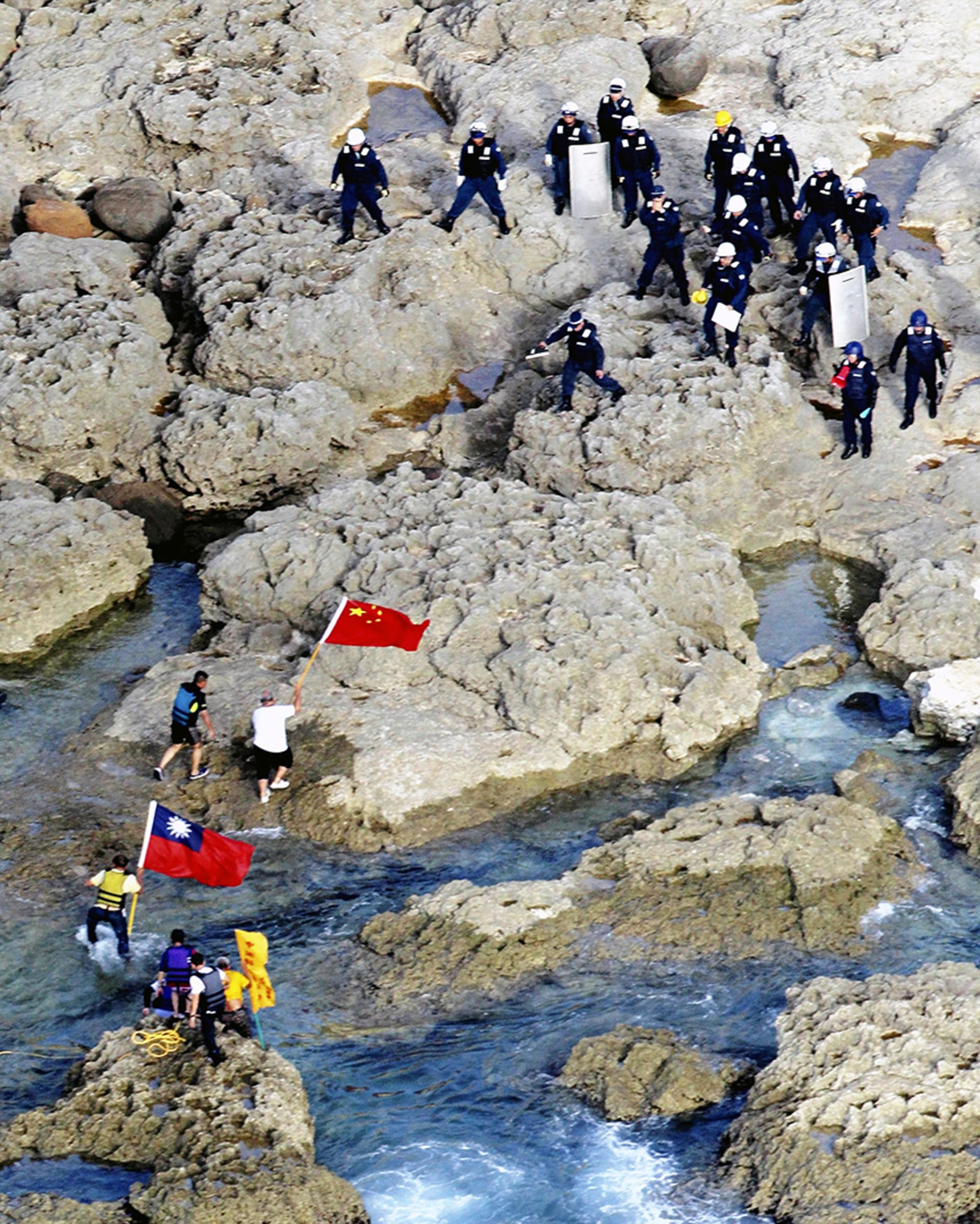 Hong Kong activists land on the Senkaku/Diaoyu Islands with Chinese and Taiwanese flags on August 15, 2012. Yomiuri Shimbun/AP Photo