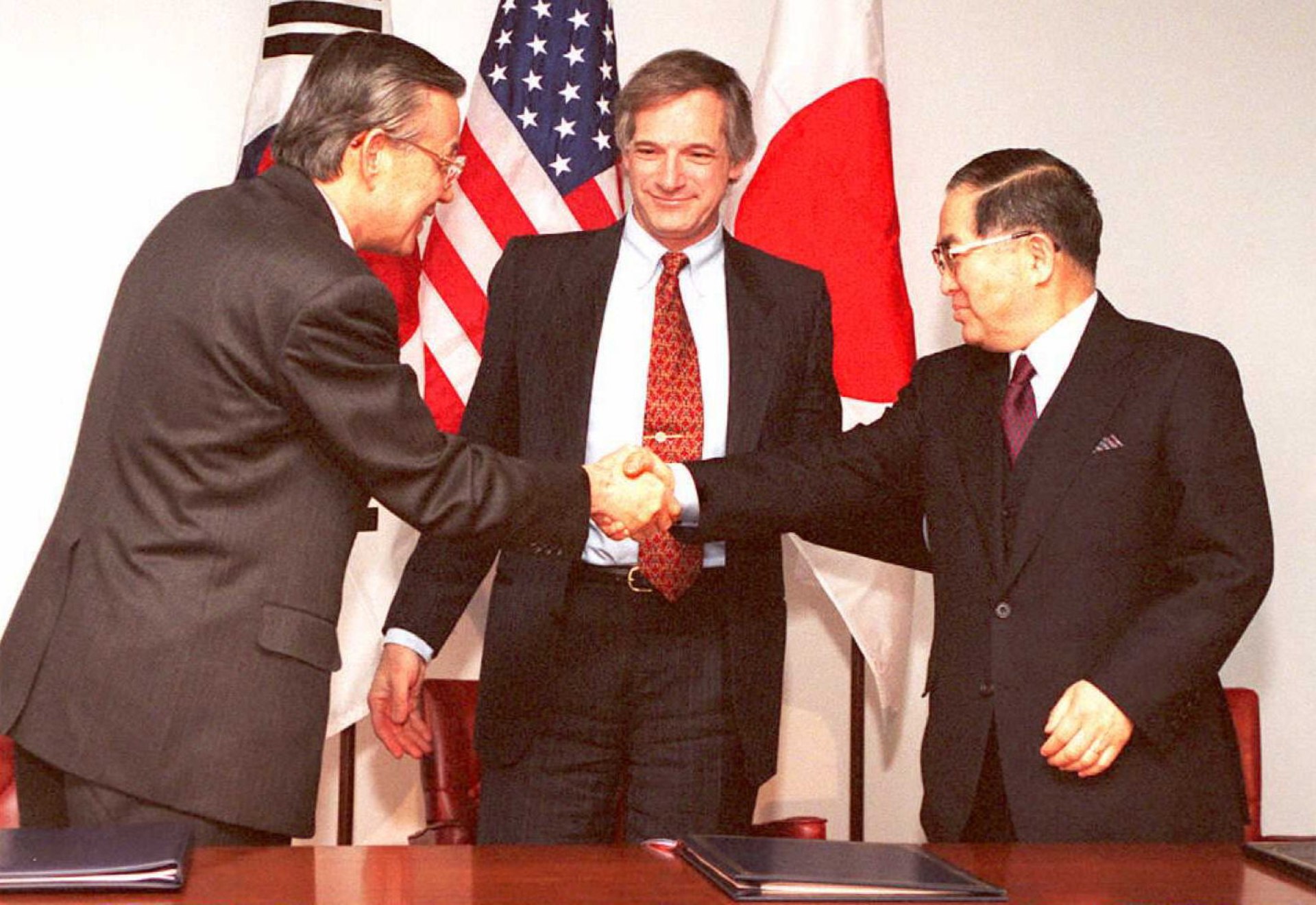 Representatives of Japan, South Korea, and the United States sign the KEDO treaty. Jon Levy/AFP via Getty Images