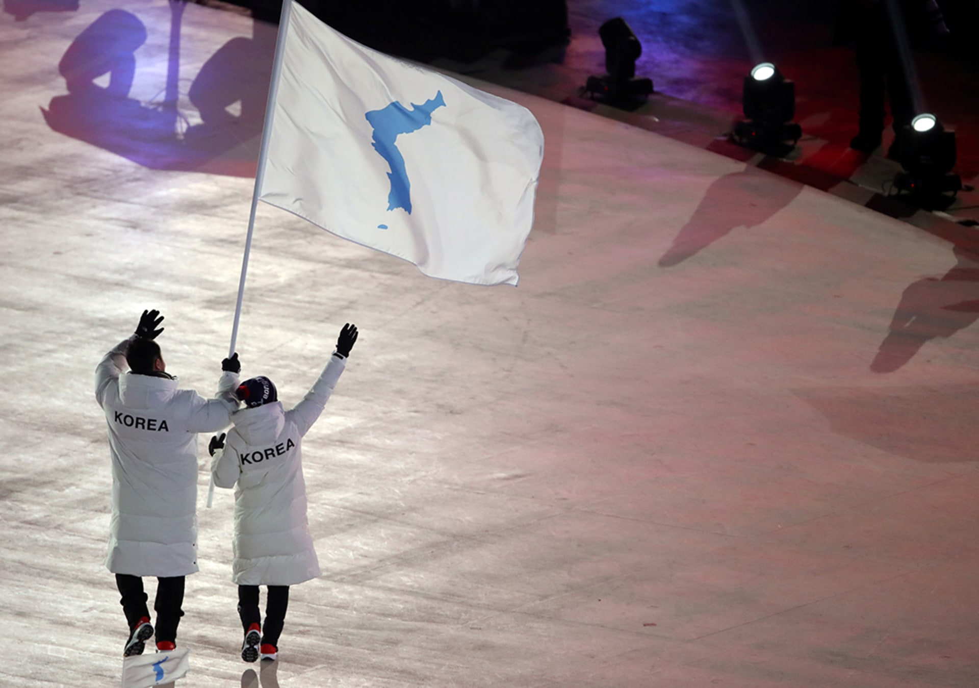 North Korean hockey player Hwang Chung-gum and South Korean bobsledder Won Yun-jong wave a flag showing the Korean Peninsula during the games in Pyeongchang, South Korea. Sean M. Haffey/Reuters