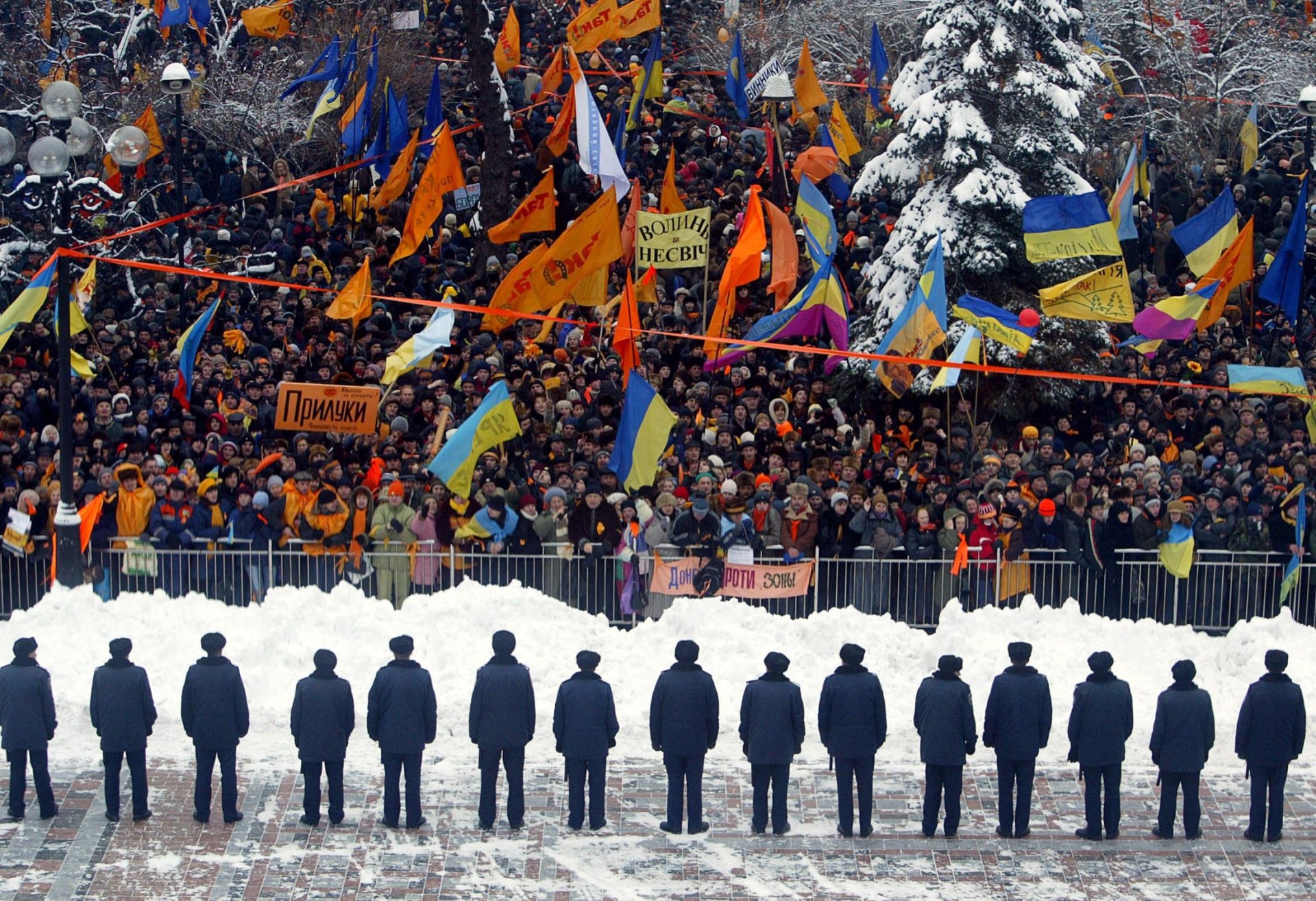 Police guard the parliament building in Kyiv as it is surrounded by opposition supporters. 
